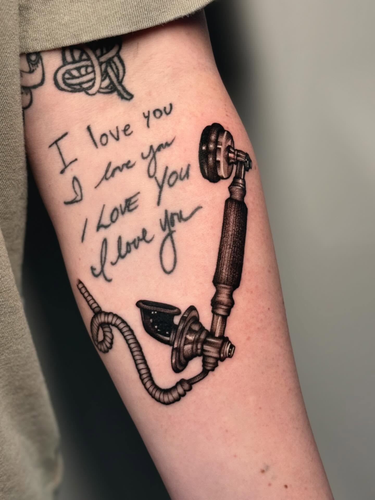 I love you black and grey tattoo on the forearm by laura baldwin
