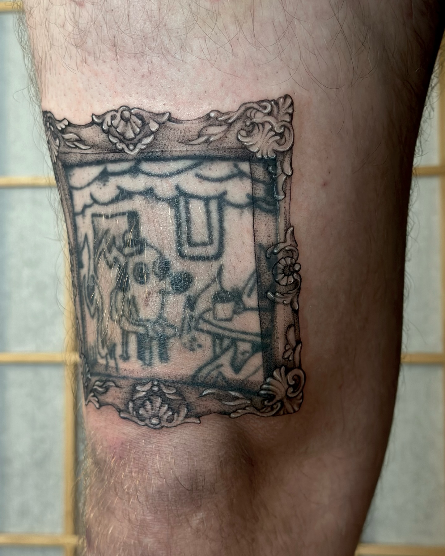 Portrait black and grey tattoo on the thigh by cora cupid