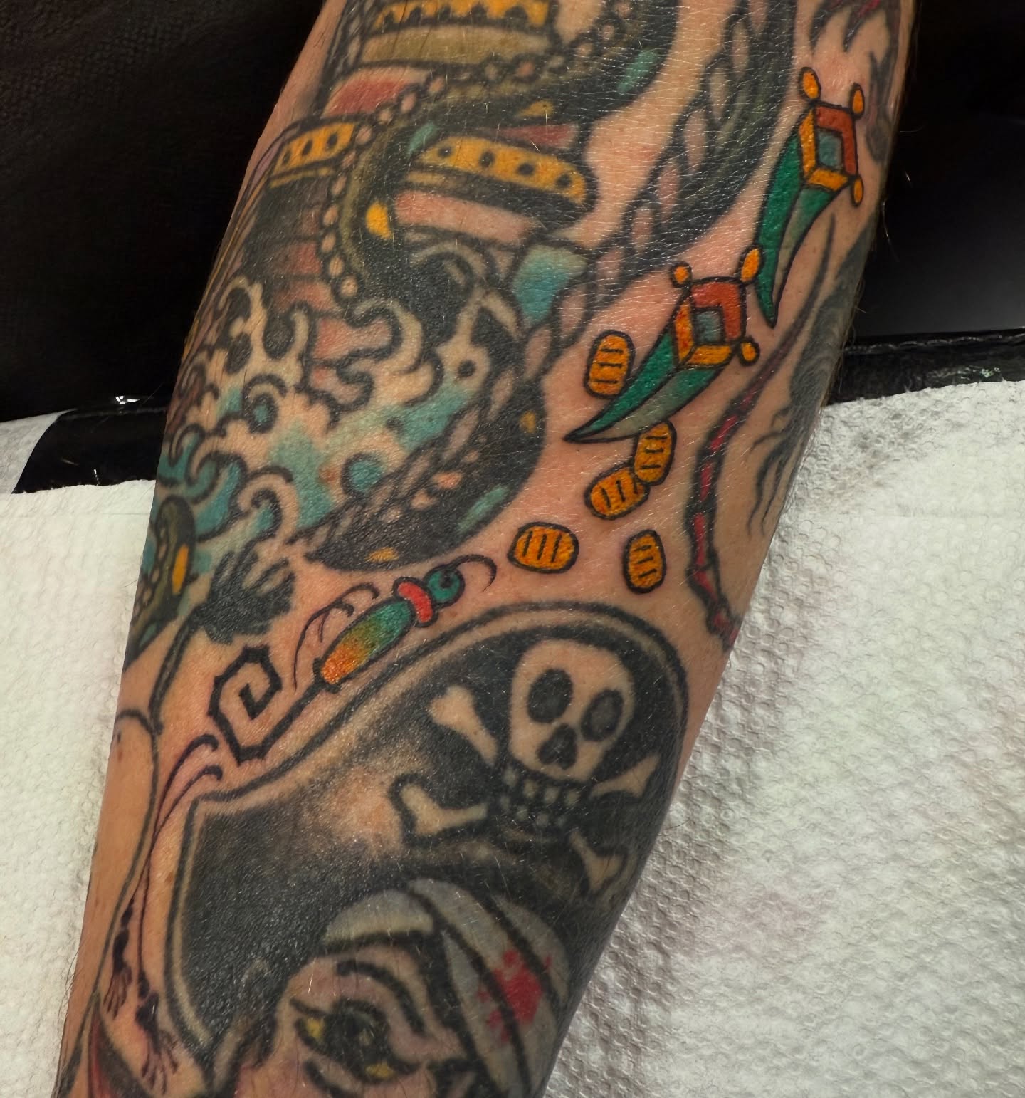 Pirate skull and crossbones American traditional tattoo on the forearm by Candi Kinyōbi