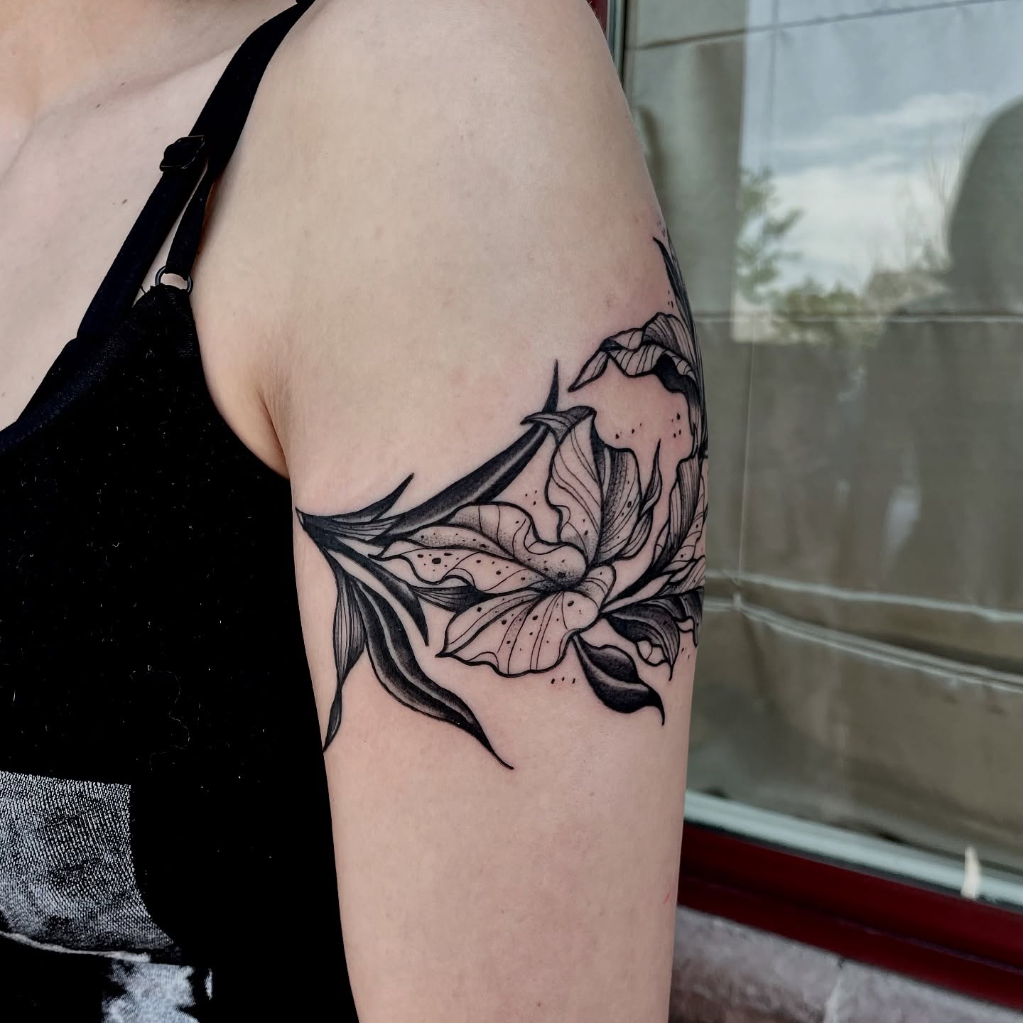 Lily dotwork tattoo on the thigh by Tattoo Artist