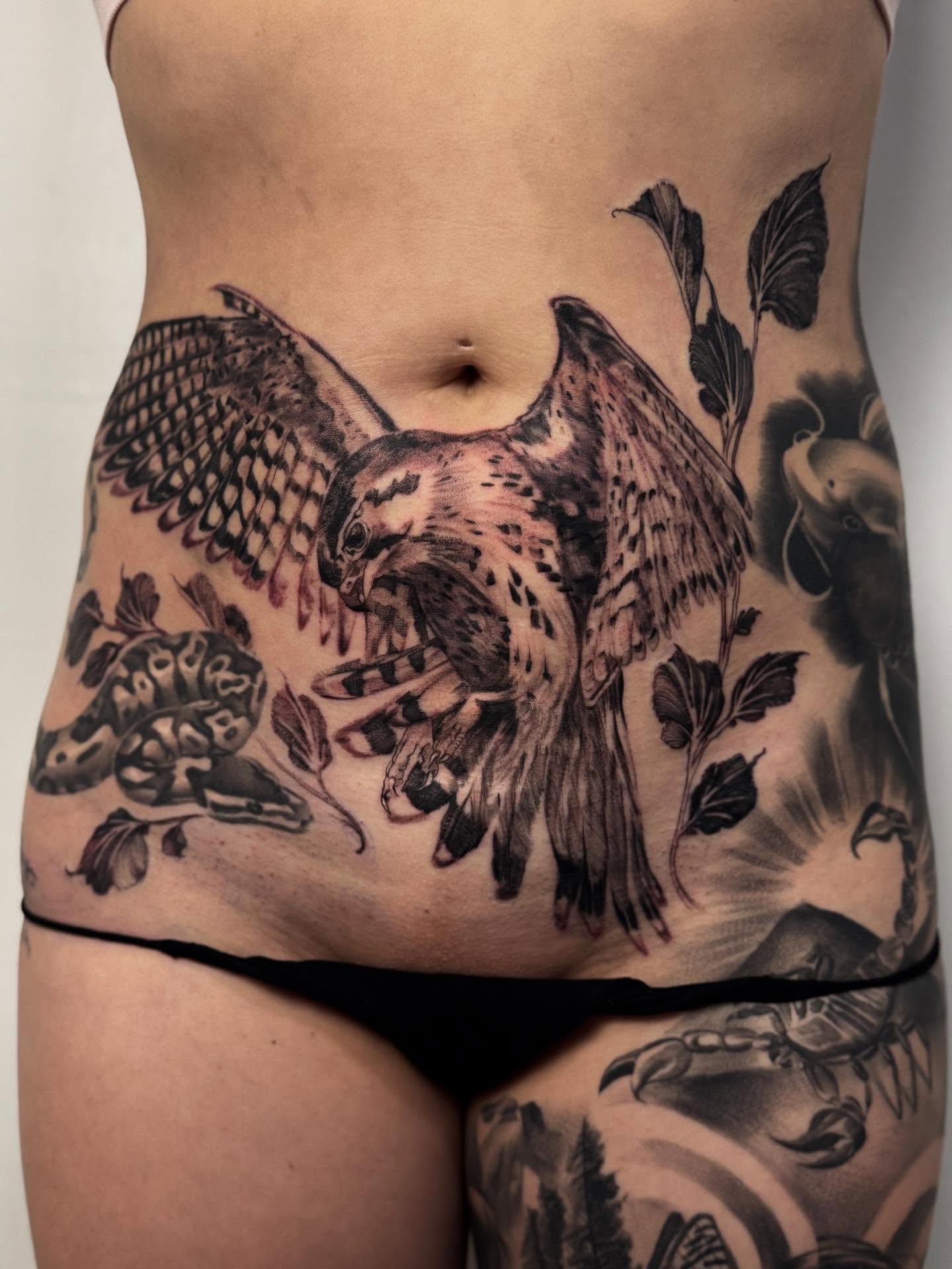 Hawk and snake realism tattoo on the torso by Tianna Osborne