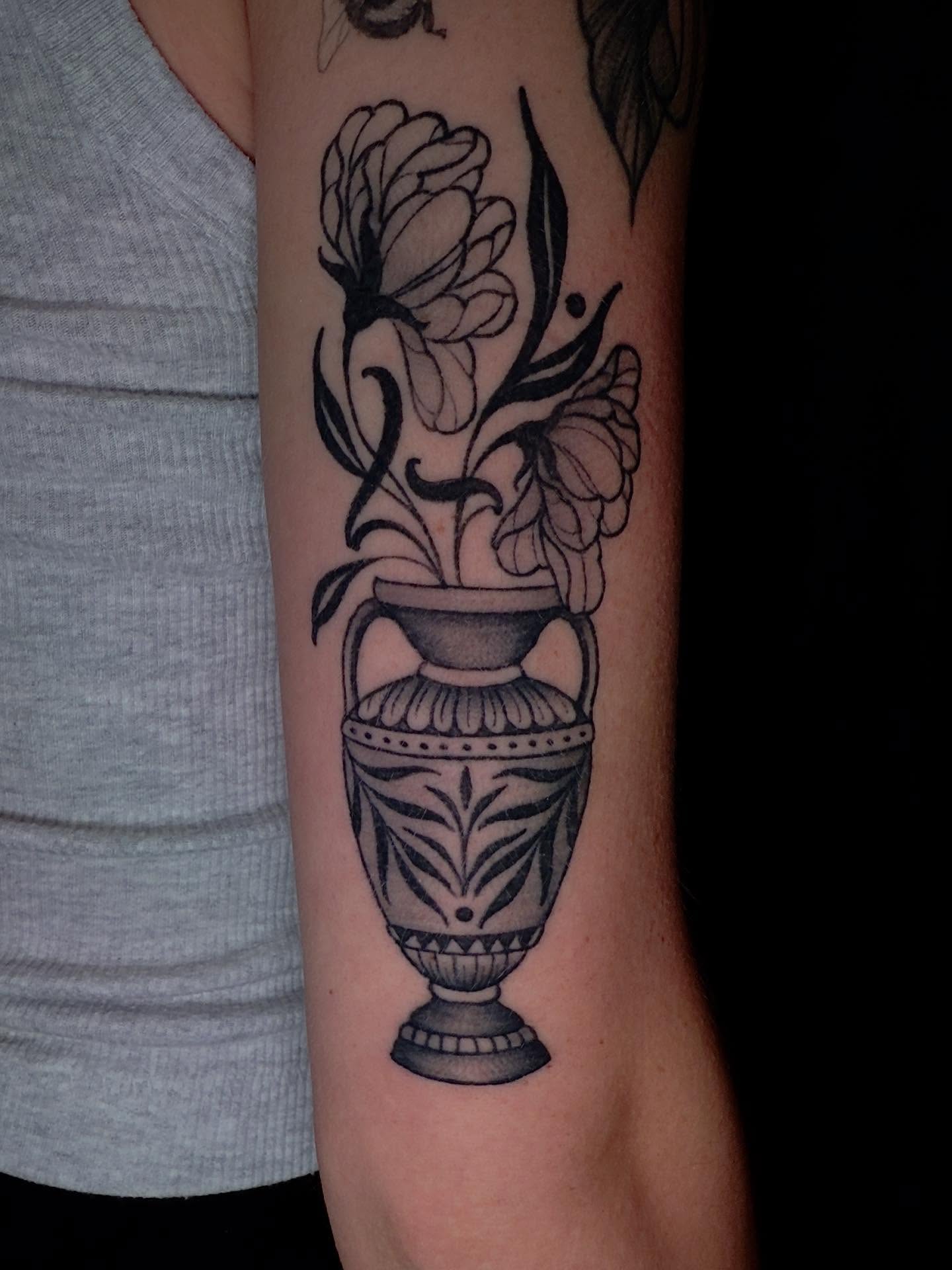 Vase with flowers black and grey tattoo on the forearm by Jessica Haug