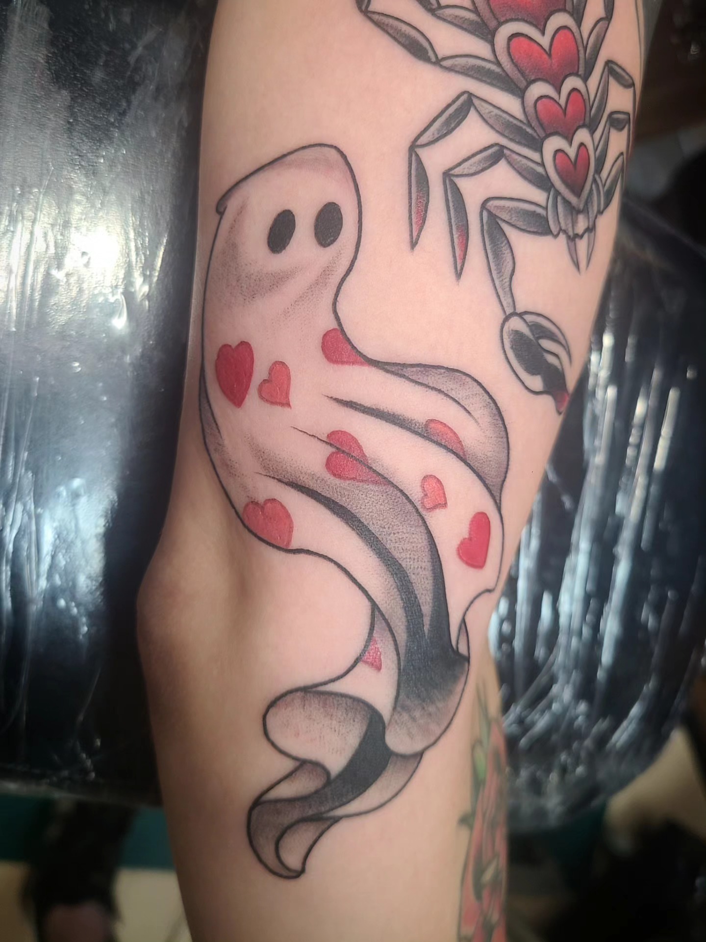 Ghost with hearts American traditional tattoo on the forearm by David Vodicka