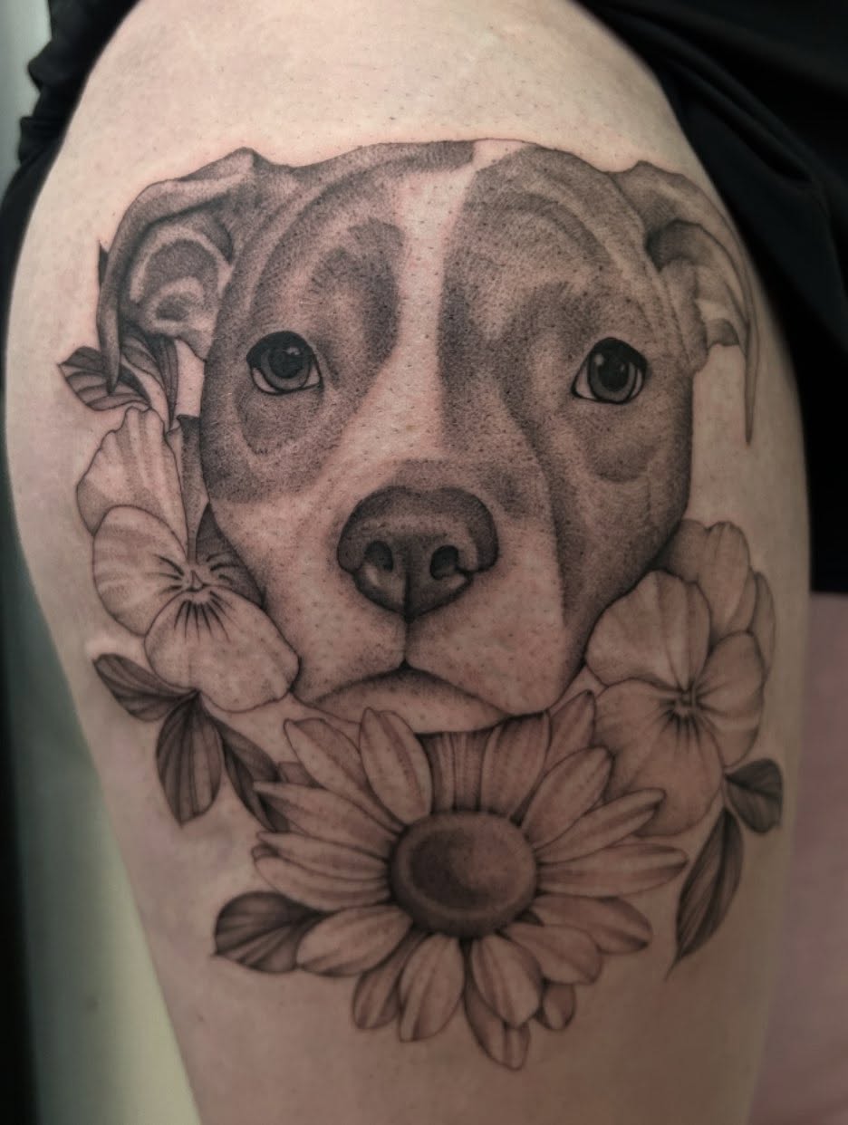 Pit bull with flowers realism tattoo on the shoulder by Olivia Fox