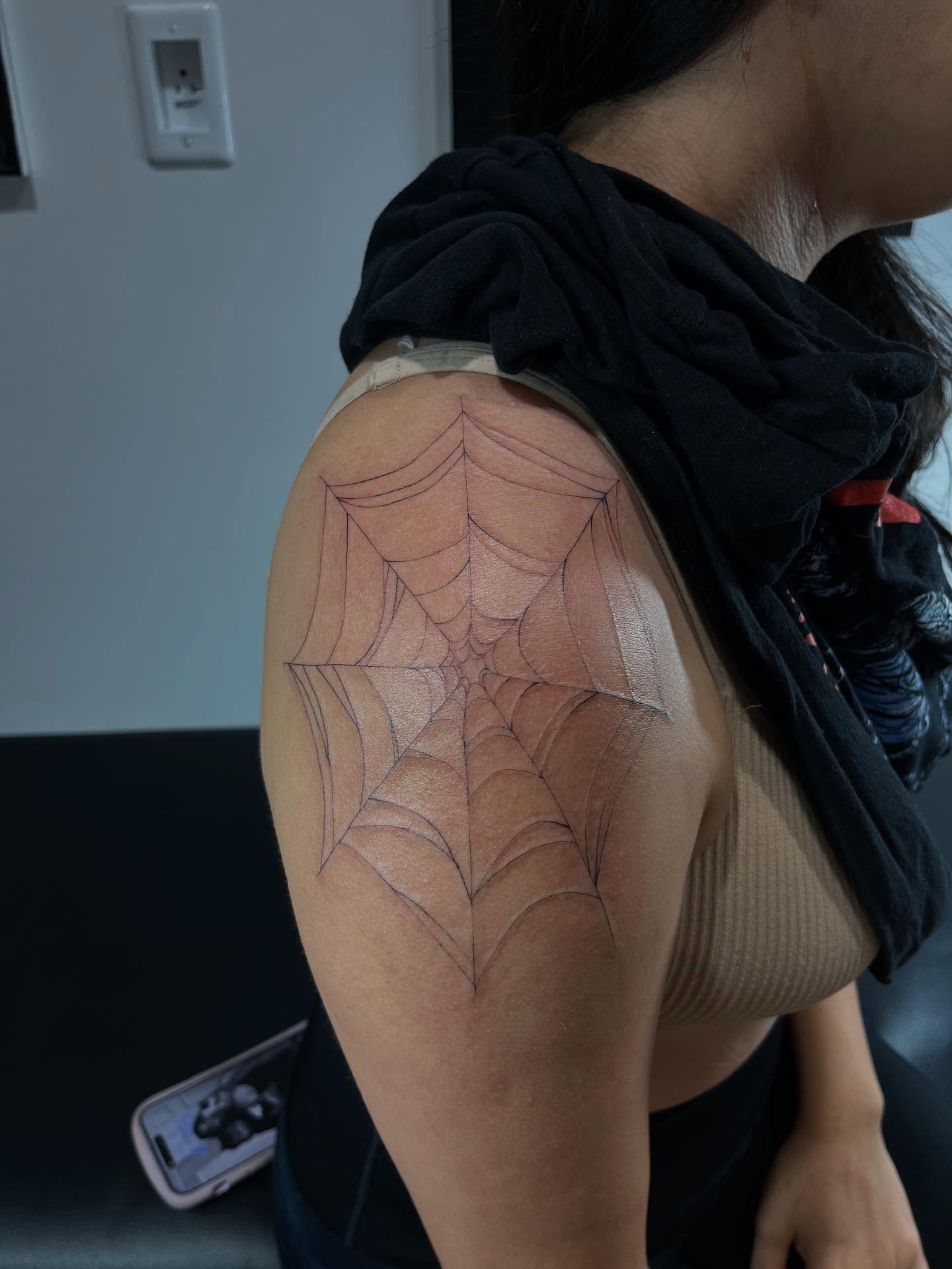Spider web geometric tattoo on the shoulder by jude tattoos