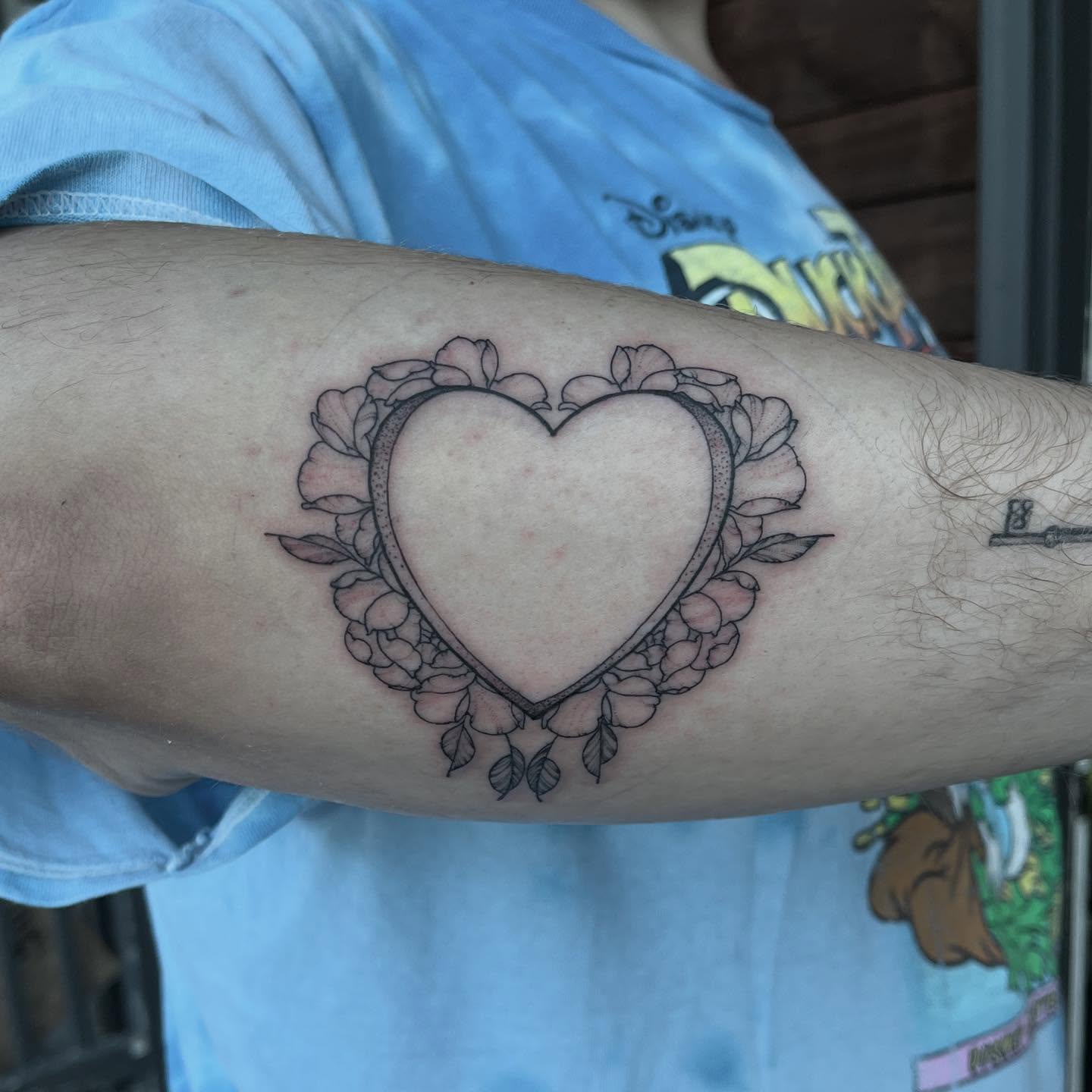 Heart black and grey tattoo on the forearm by Dallas Davis