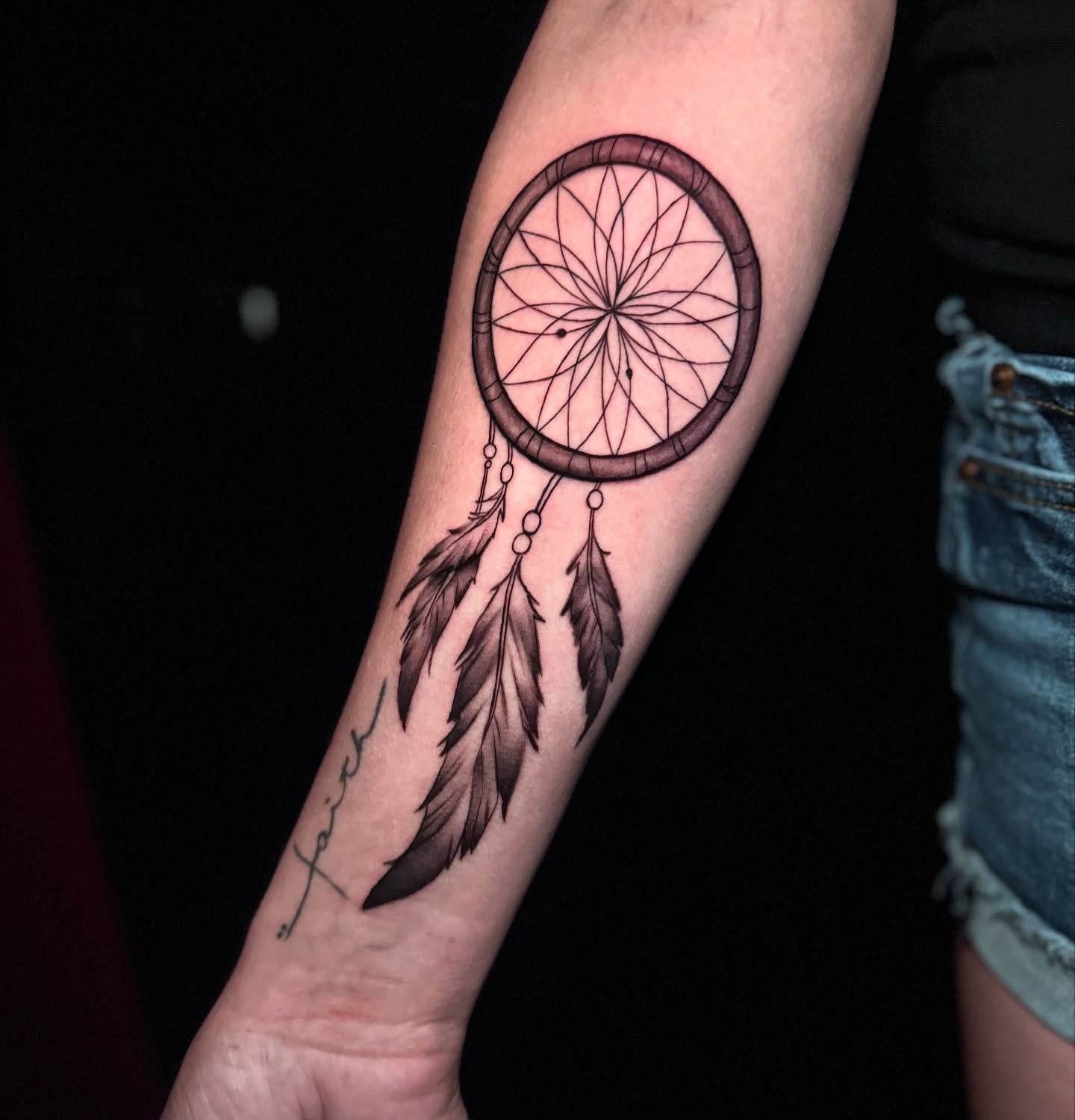 Dreamcatcher black and grey tattoo on the forearm by Ryland - Tattoo Artist