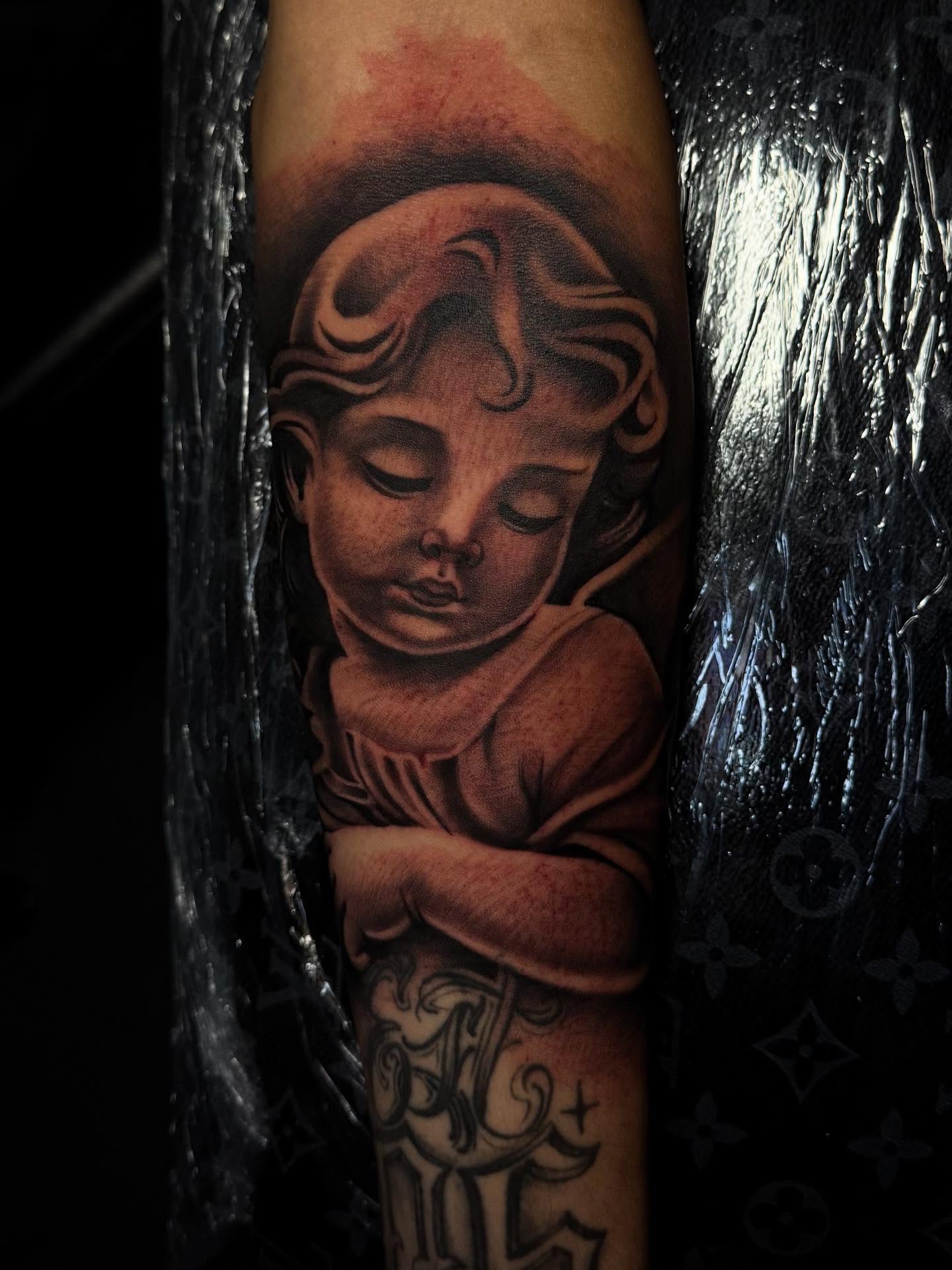 Sleeping child realism tattoo on the forearm by Smuk One