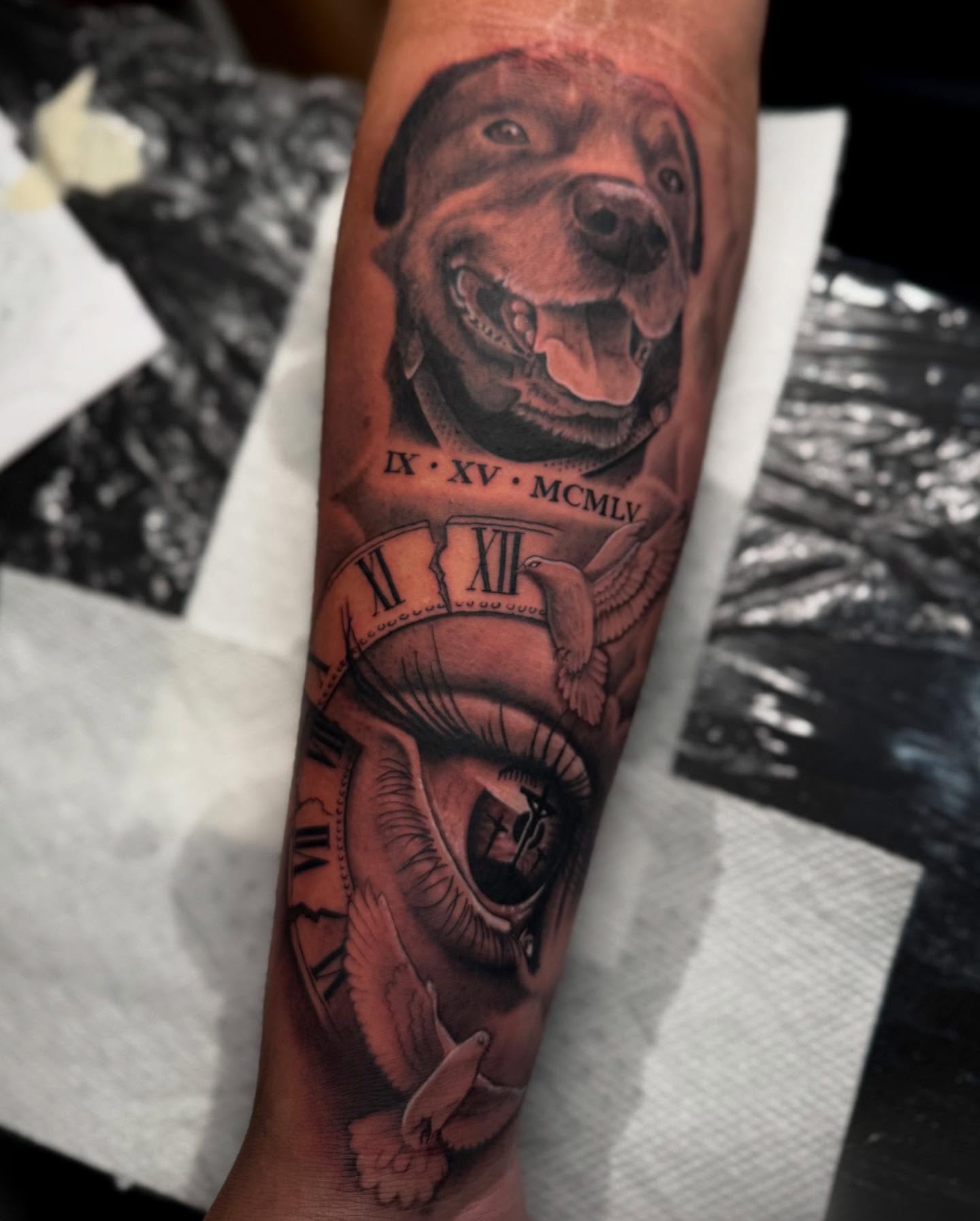 Dog and clock realism tattoo on the forearm by Denver Tattoo Artist