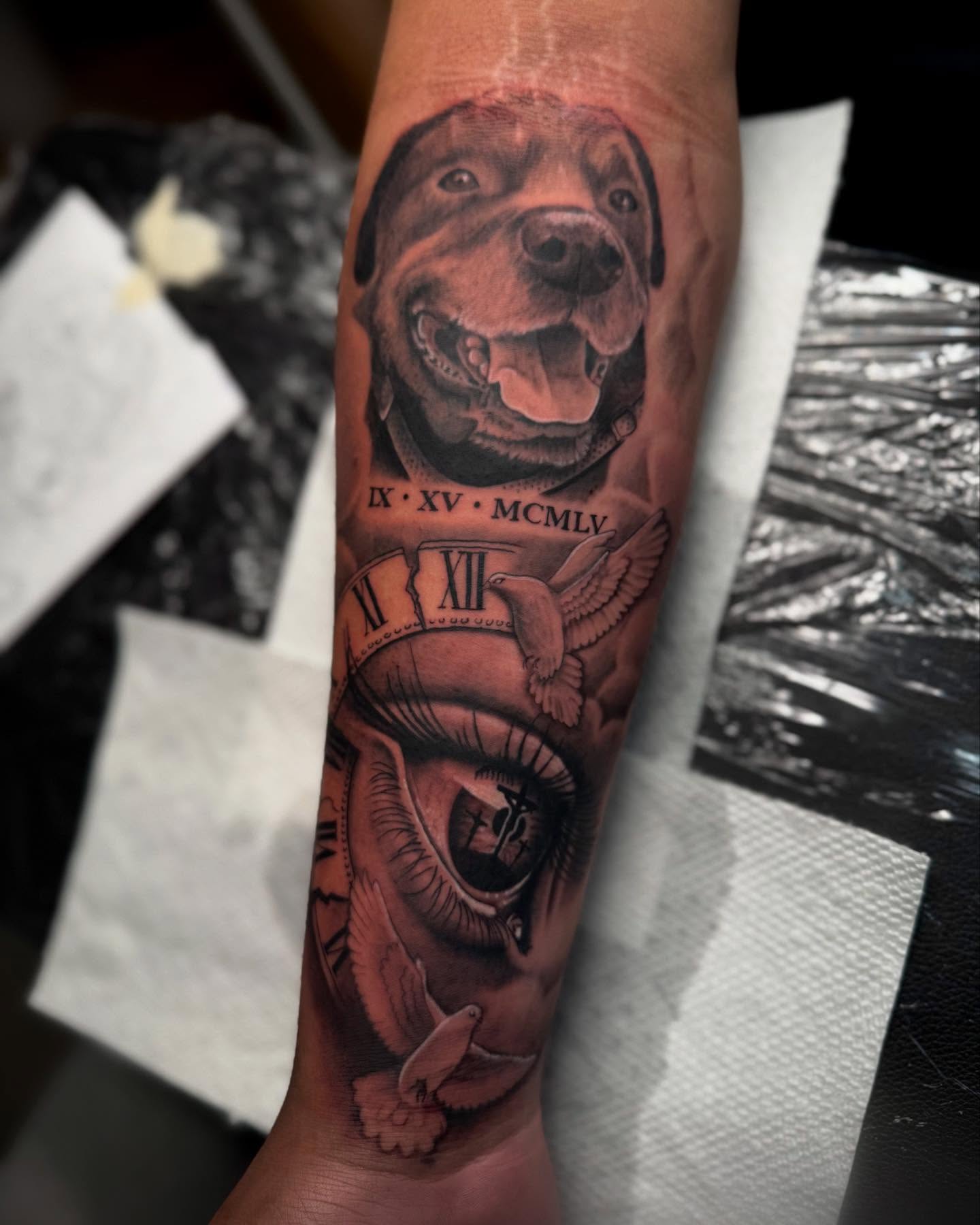 Dog and eye realism tattoo on the forearm by Denver Tattoo Artist