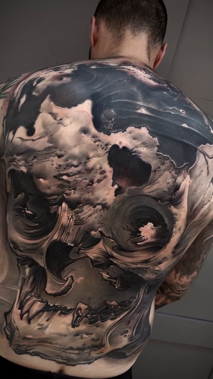 Skull with clouds dark realism tattoo by Robert Hernandez