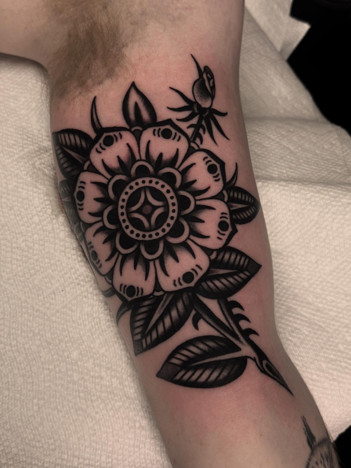 Flower bouquet black and grey tattoo on the forearm by Ryan Engels