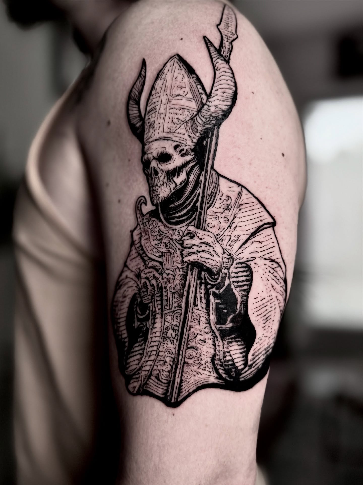 Skull in bishop's attire dark realism tattoo on the shoulder by Bwk Dark Art