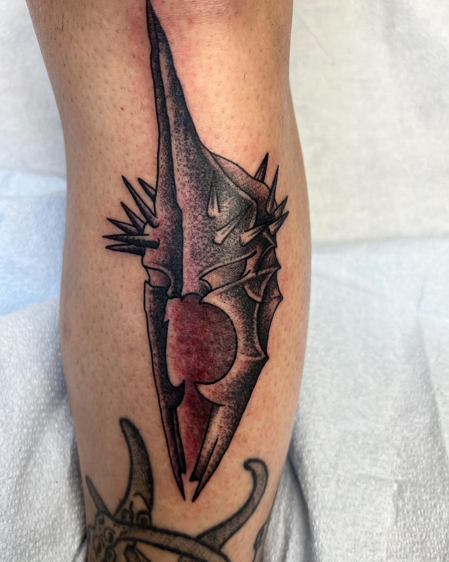 Heart with dagger black and grey tattoo on the forearm by Cody Marl