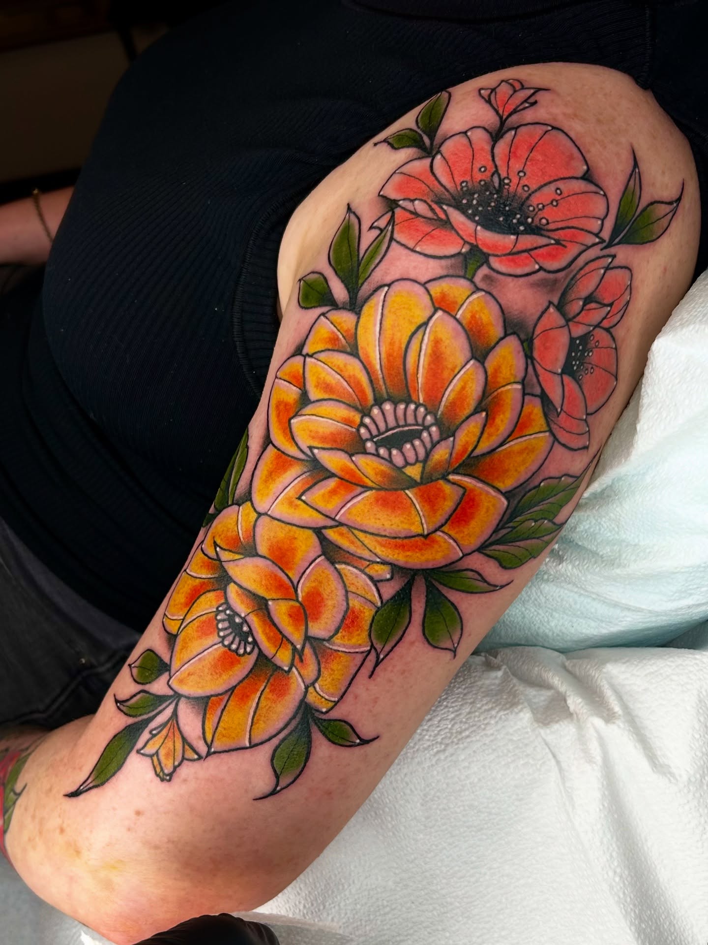 Floral bouquet American traditional tattoo on the forearm by Noah Crow