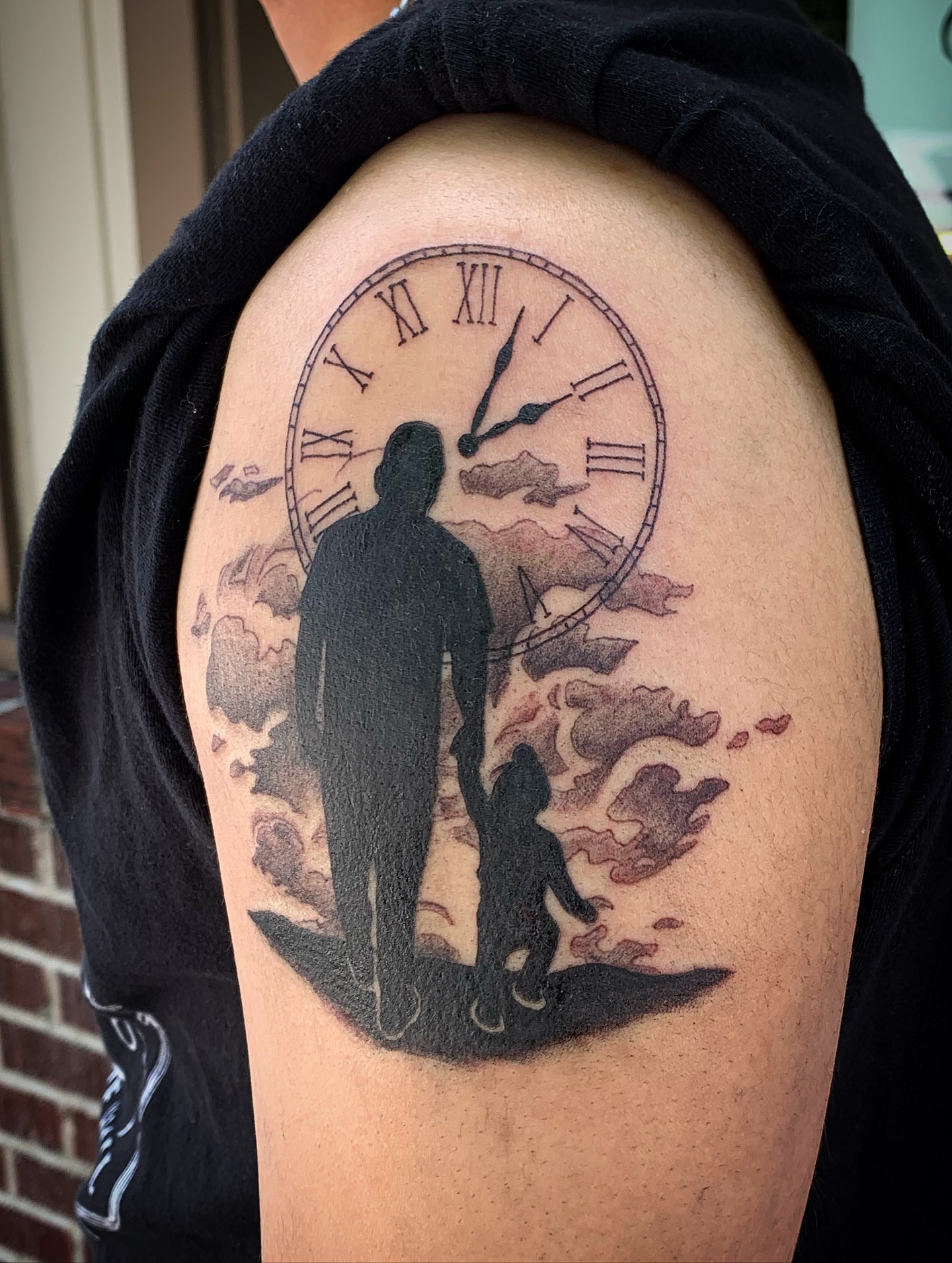 Clock and figures realism tattoo on the shoulder by Laura