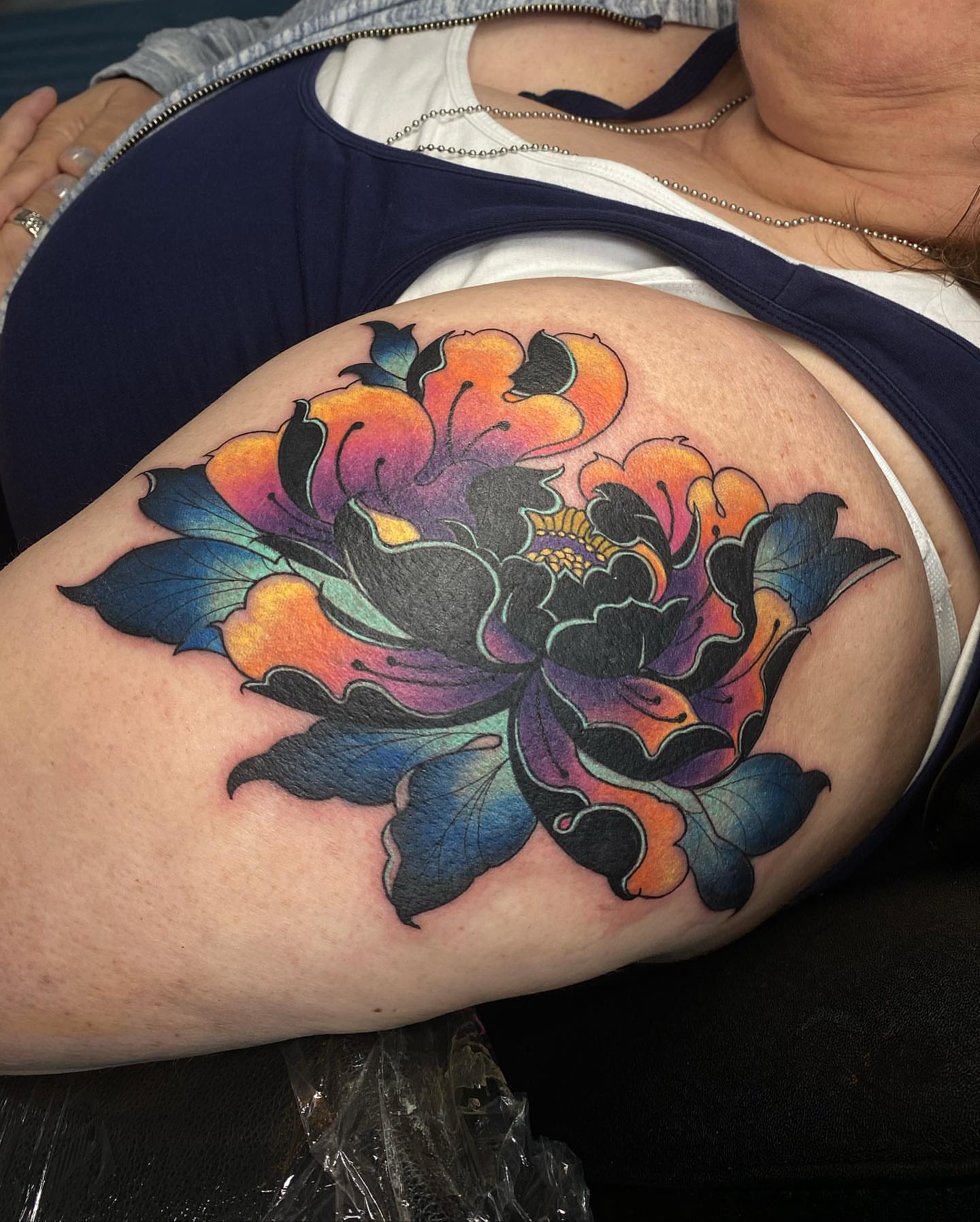 Floral American traditional tattoo on the shoulder by Maddie Neibert