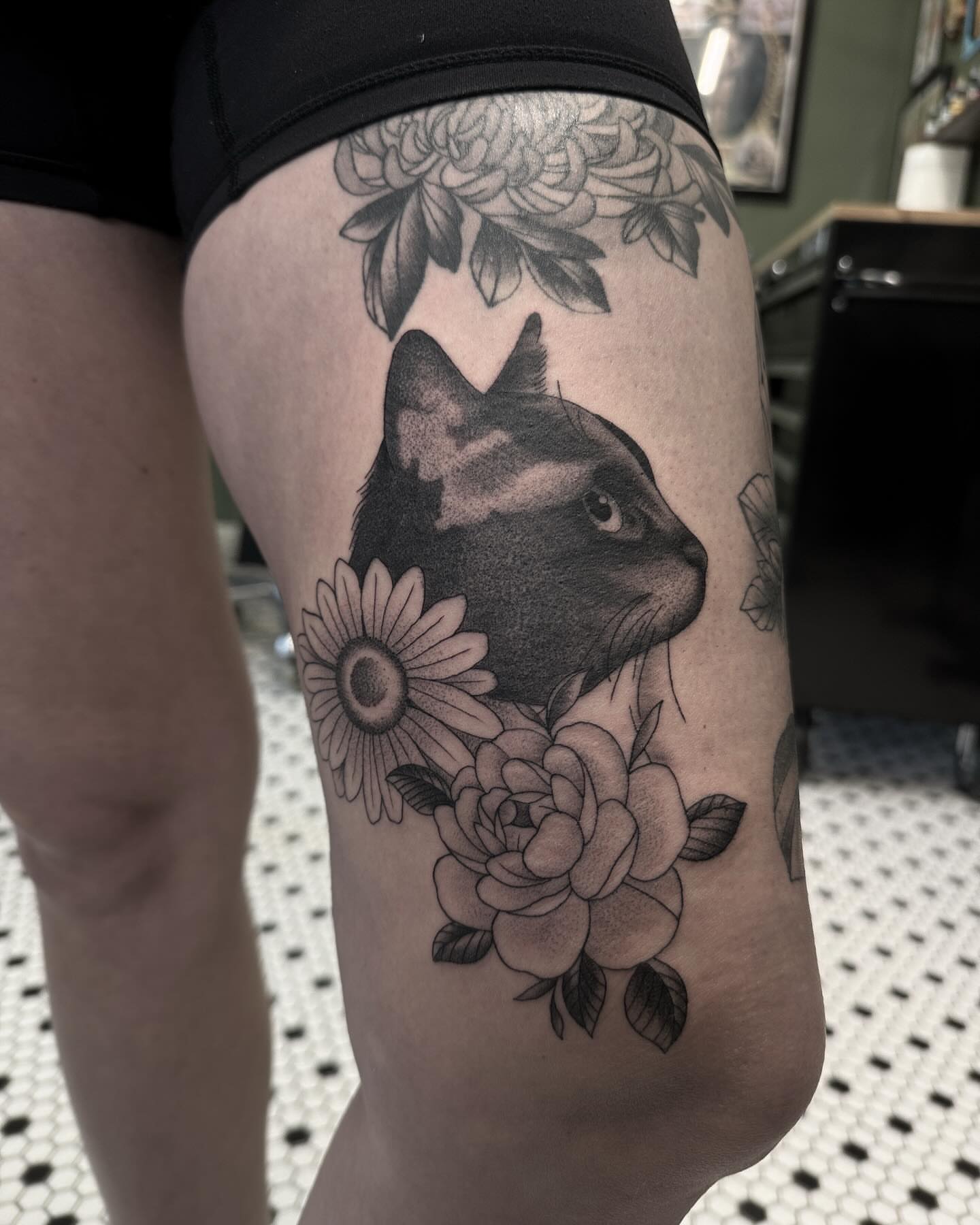 Cat and flowers realism tattoo on the thigh by Blake Owens, Nashville, Tennessee