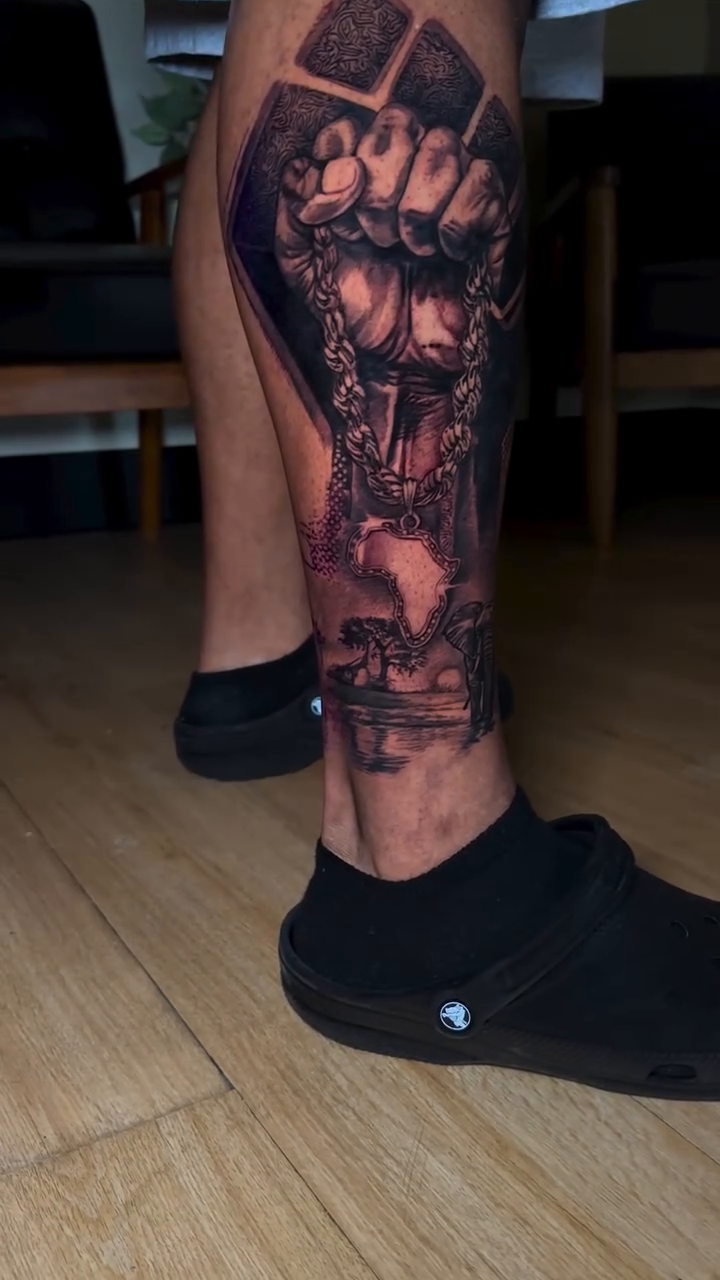 Fist with skull and chains dark realism tattoo by Abel Deida