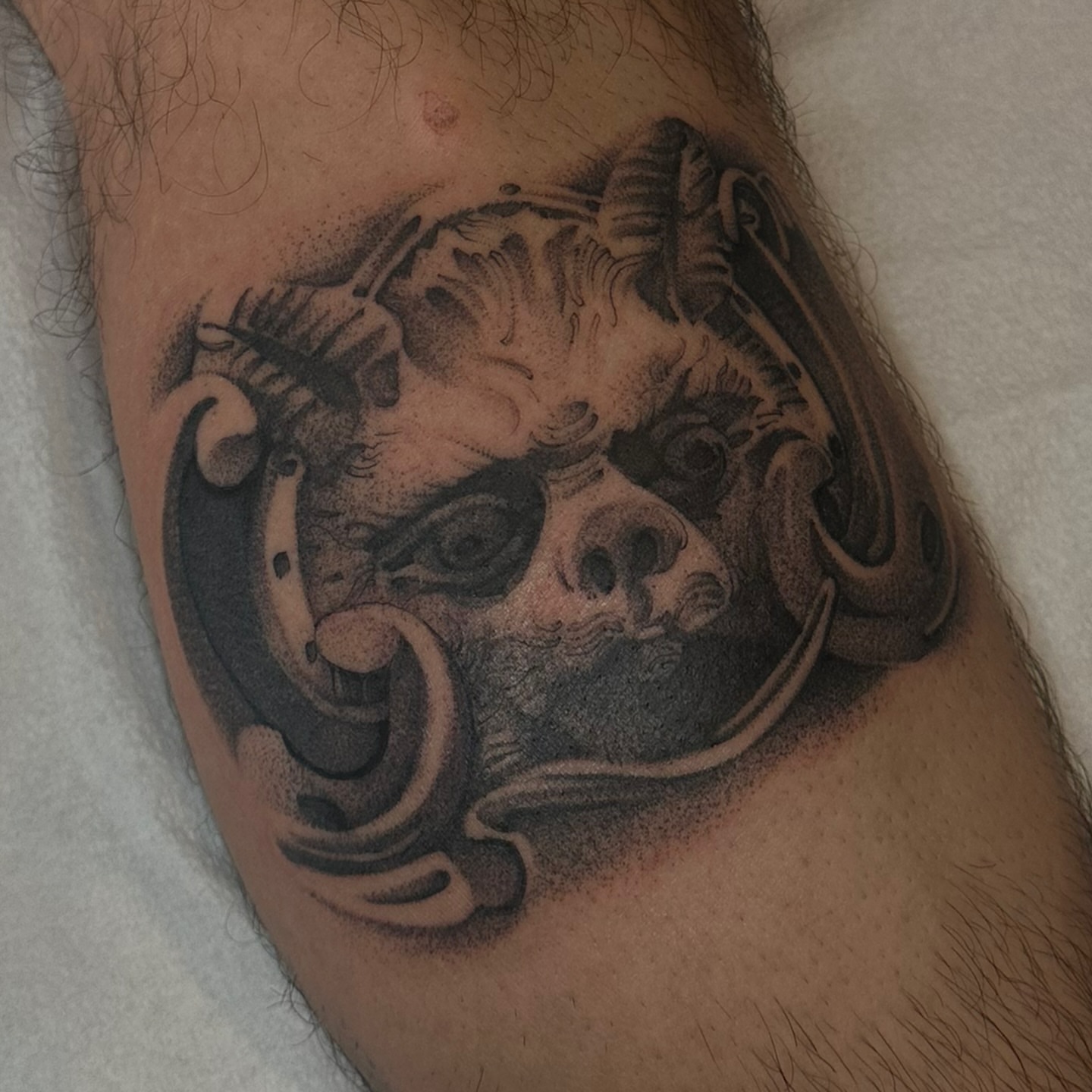 Mechanical skull realism tattoo on the forearm by Joe Cruz