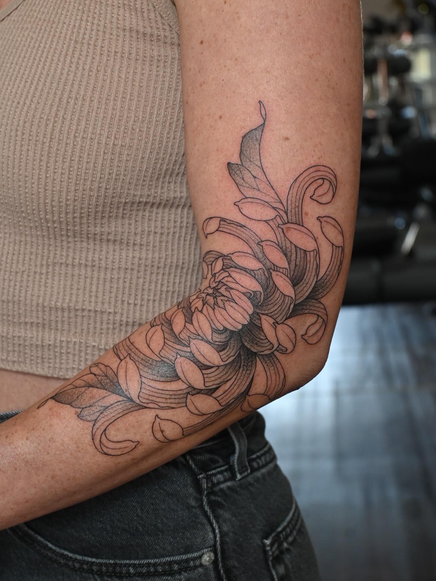 Floral design black and grey tattoo on the forearm by Simba Nguyen