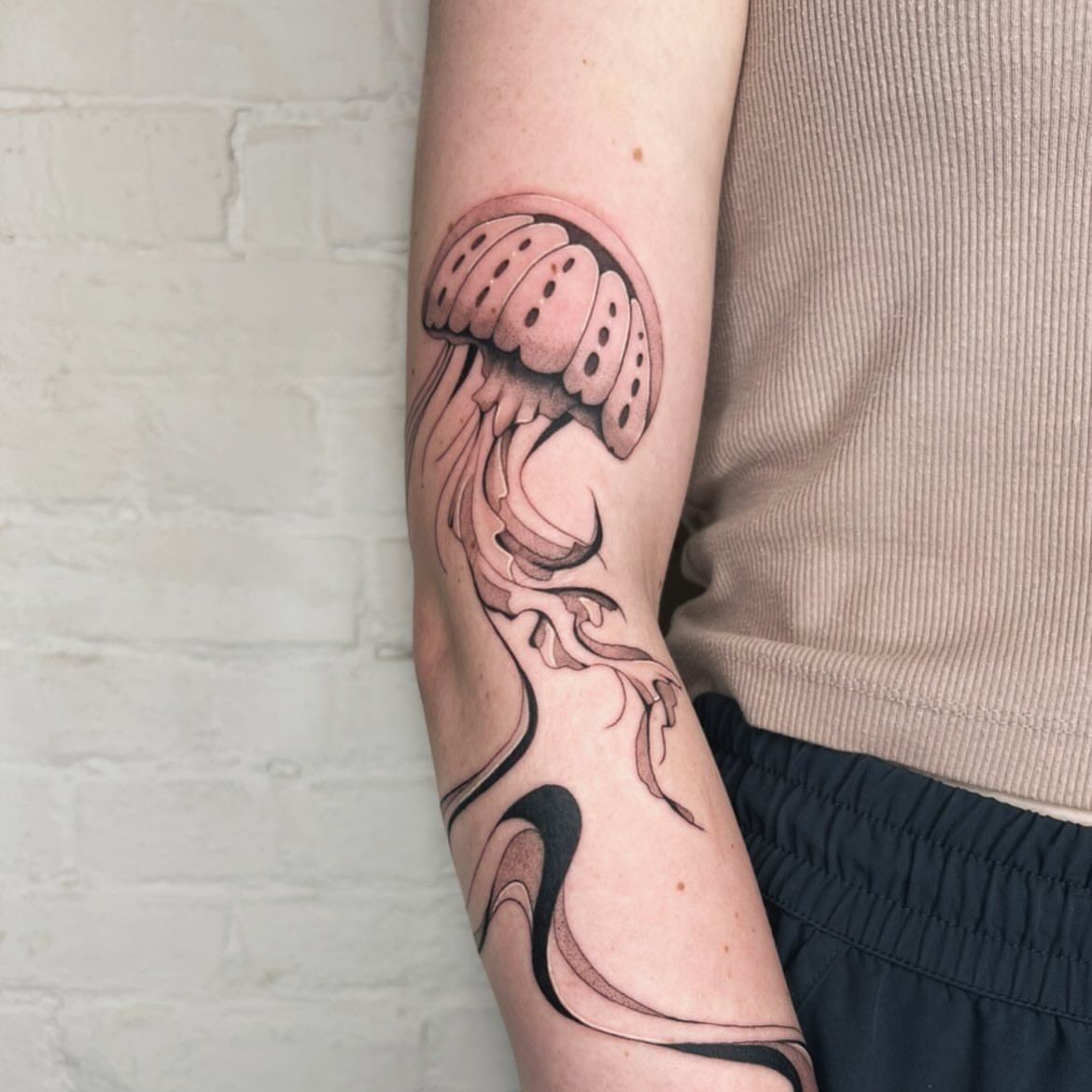 Jellyfish realism tattoo on the forearm by Robb Wilson