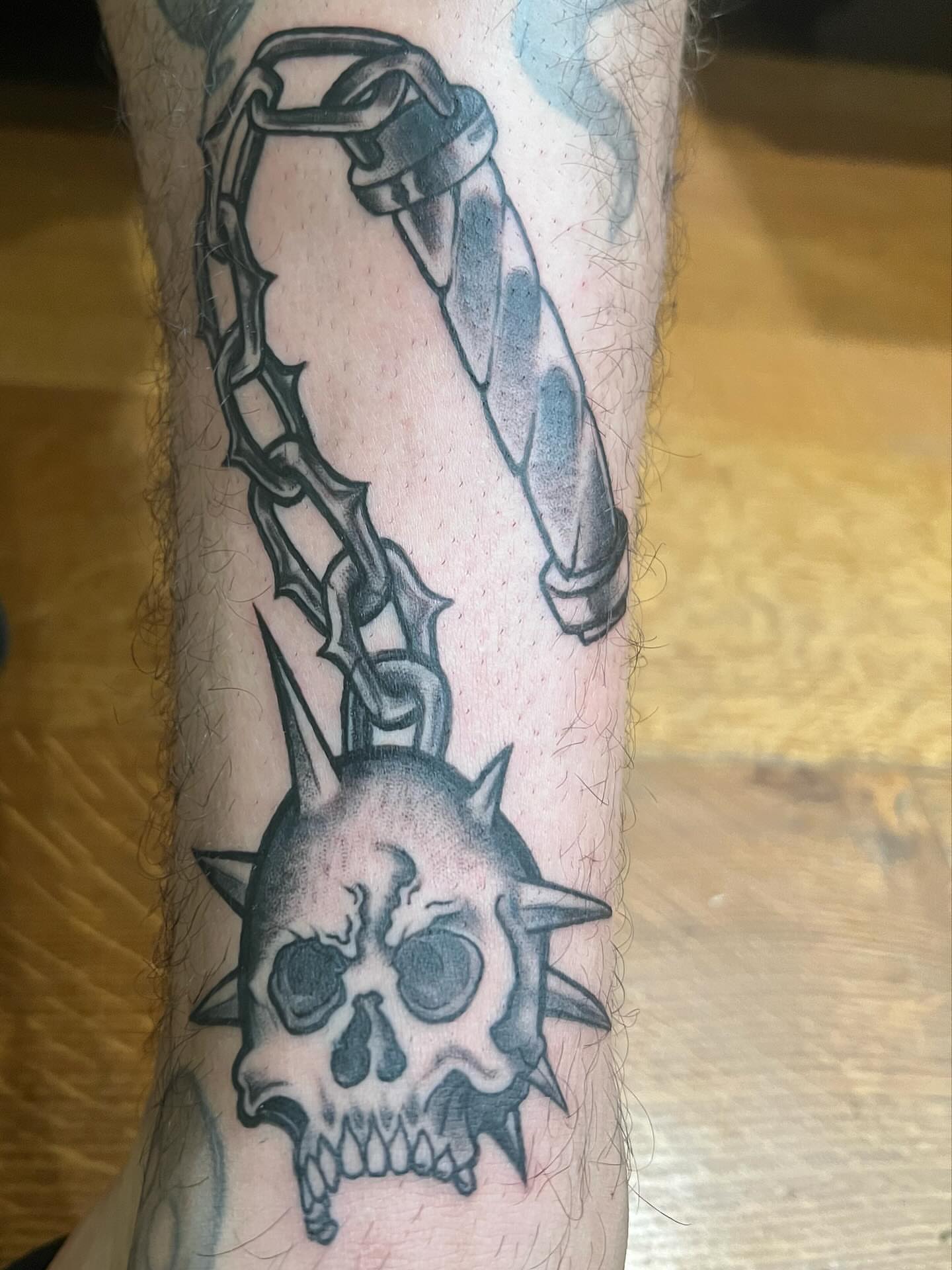 Skull and chain black and grey tattoo on the forearm by zion