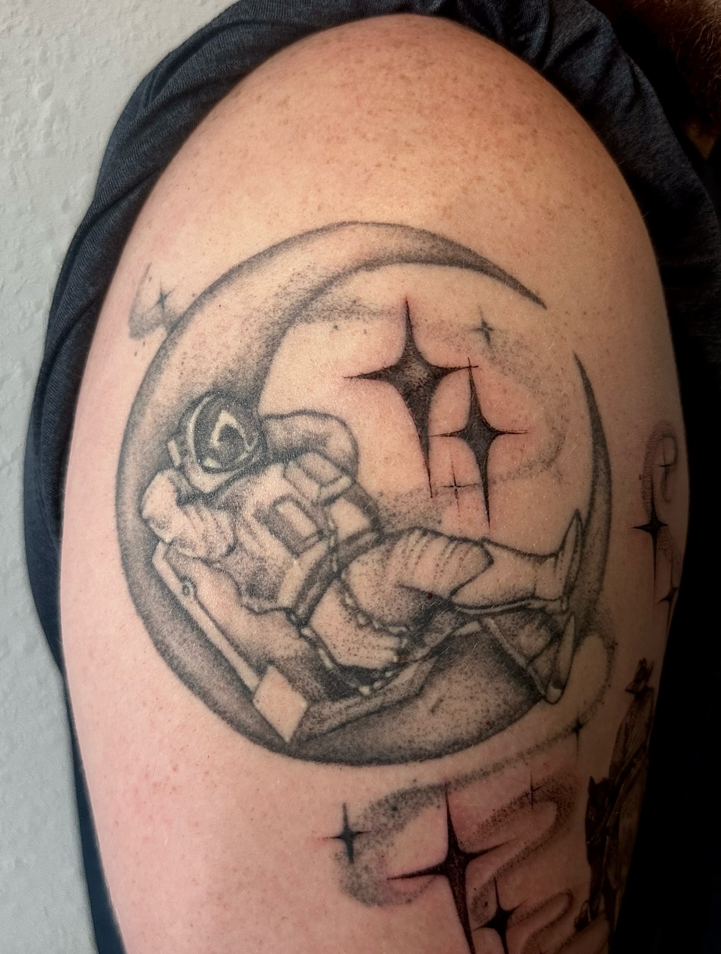 Space helmet dotwork tattoo on the shoulder by cora cupid