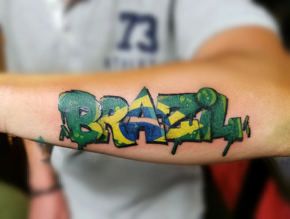 Brazil lettering script tattoo on the forearm by Ink of Winchester