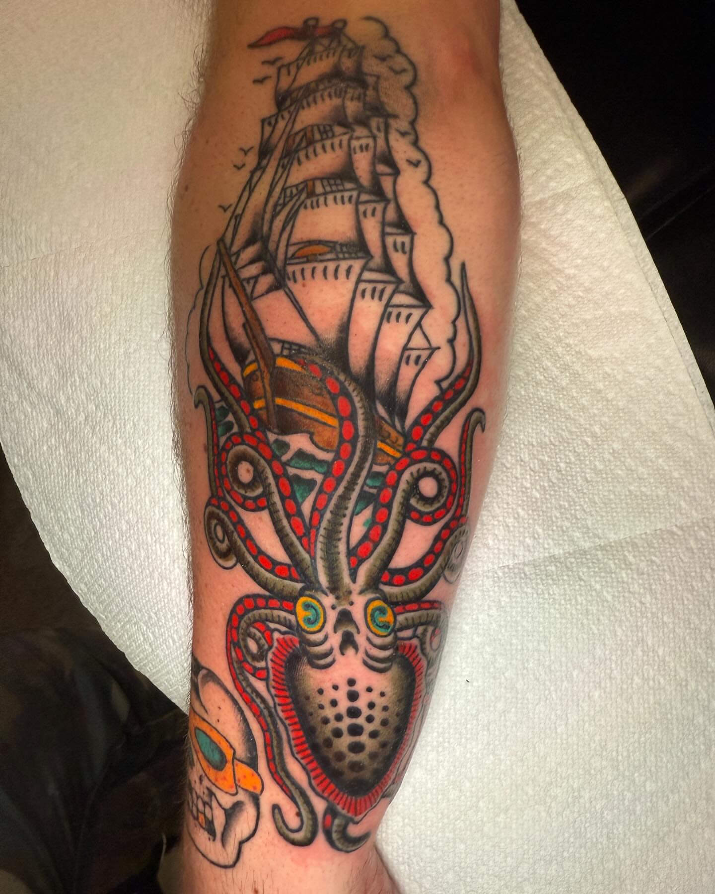 Ship and octopus American traditional tattoo on the forearm by Seth Walker