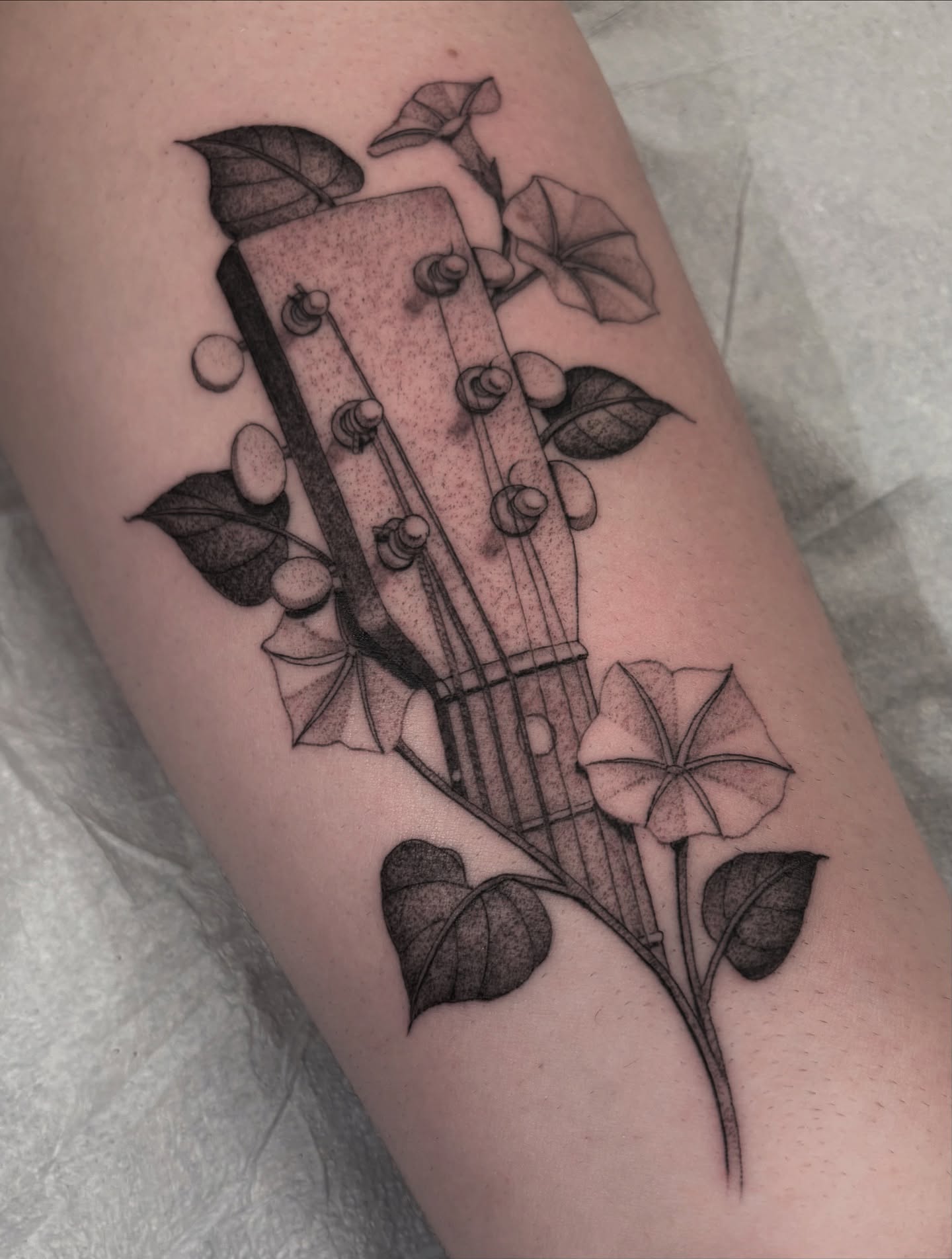 Guitar and flowers dotwork tattoo on the forearm by Jake Hodson, Nashville, Tennessee