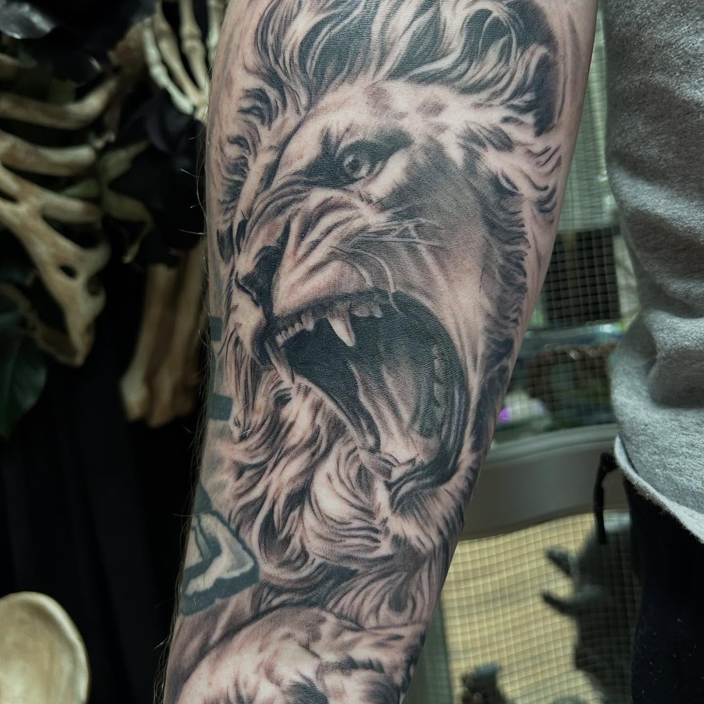 Roaring lion realism tattoo on the forearm by Josh Williams, Chattanooga, Tennessee