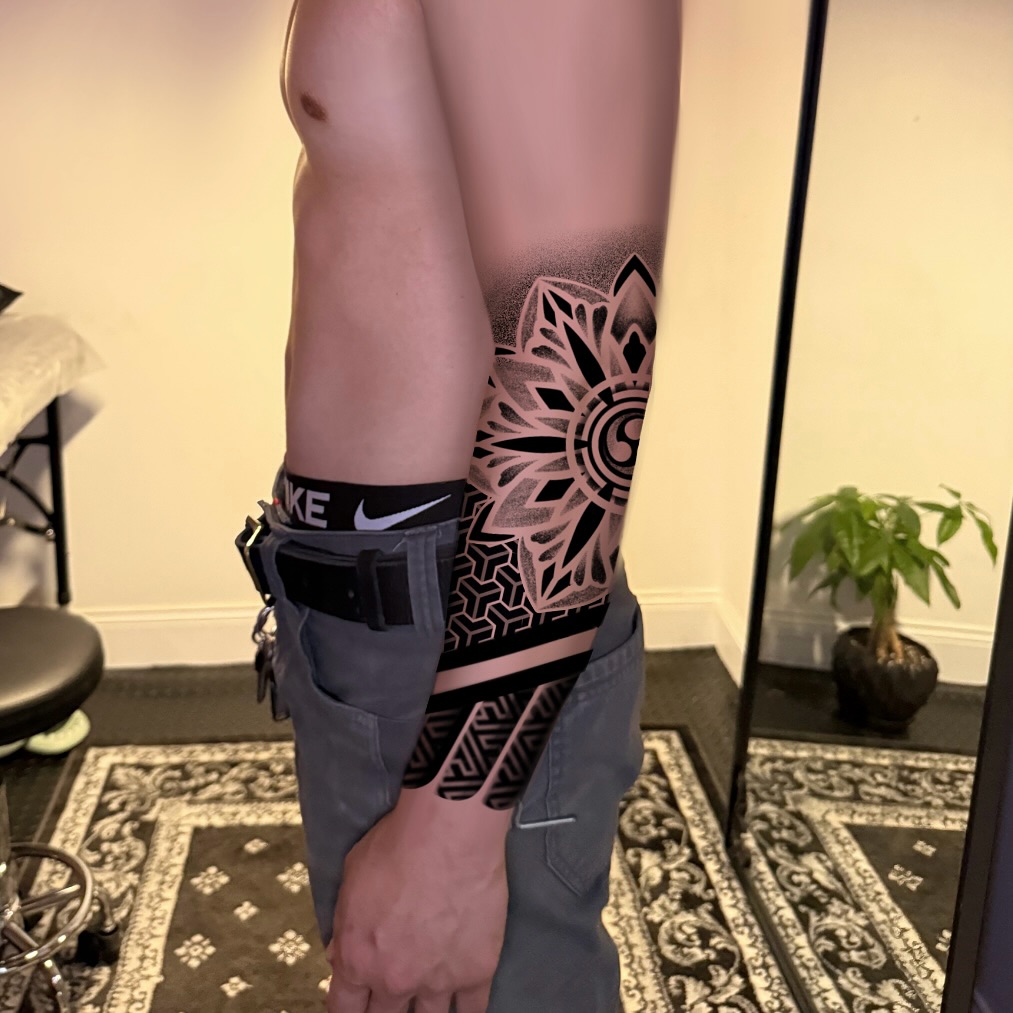 Geometric mandala with yin yang tribal tattoo on the upper arm by Ivy lee