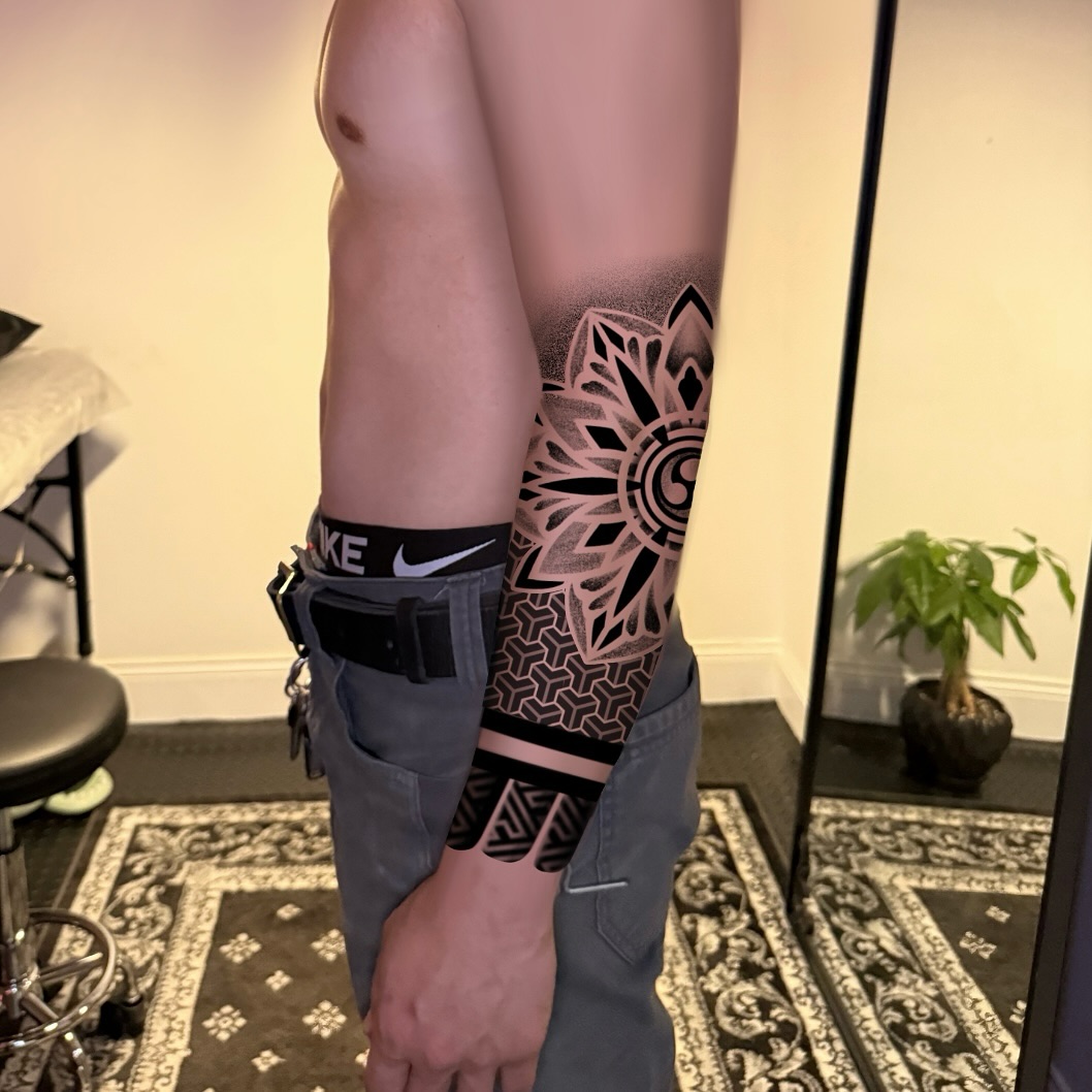 Geometric mandala and pattern tribal tattoo on the upper arm by Ivy lee