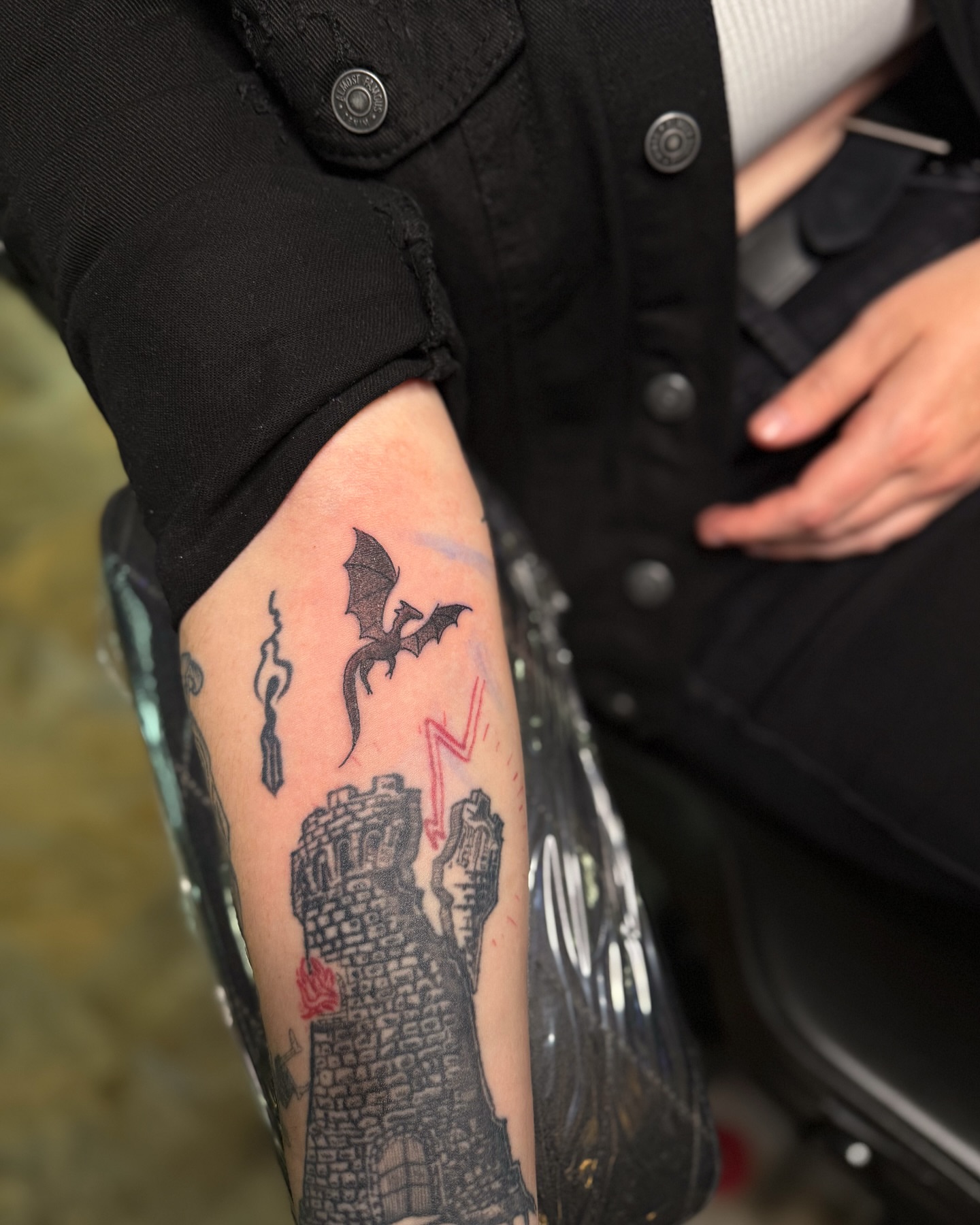 Castle ruins and bat black and grey tattoo on the forearm by Yohana Vargas