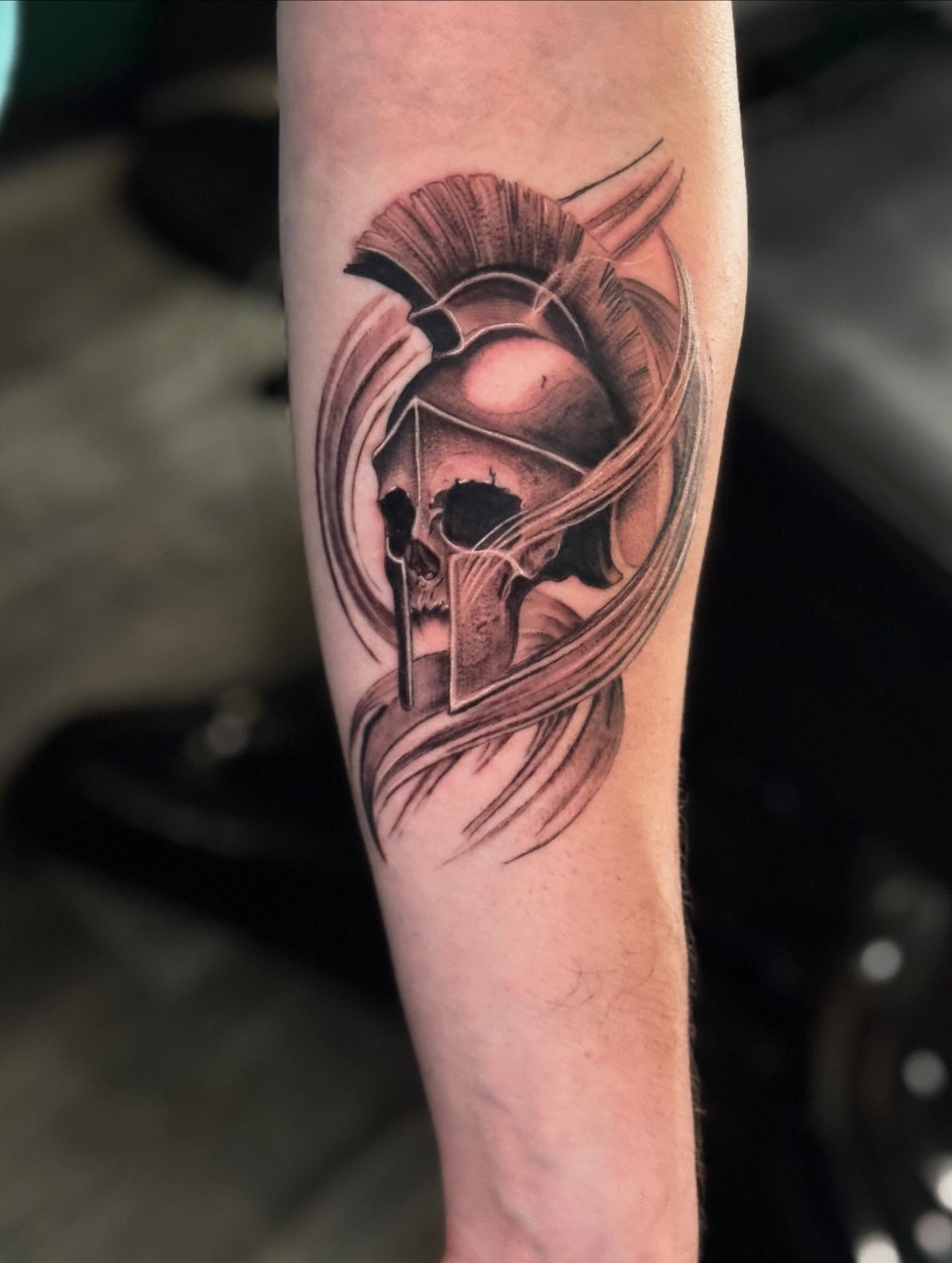 Spartan helmet realism tattoo on the forearm by Leslea Hipp