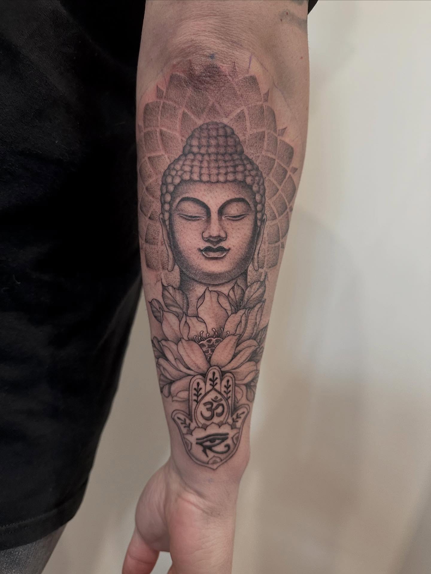 Buddha head dotwork tattoo on the forearm by Kate Darling
