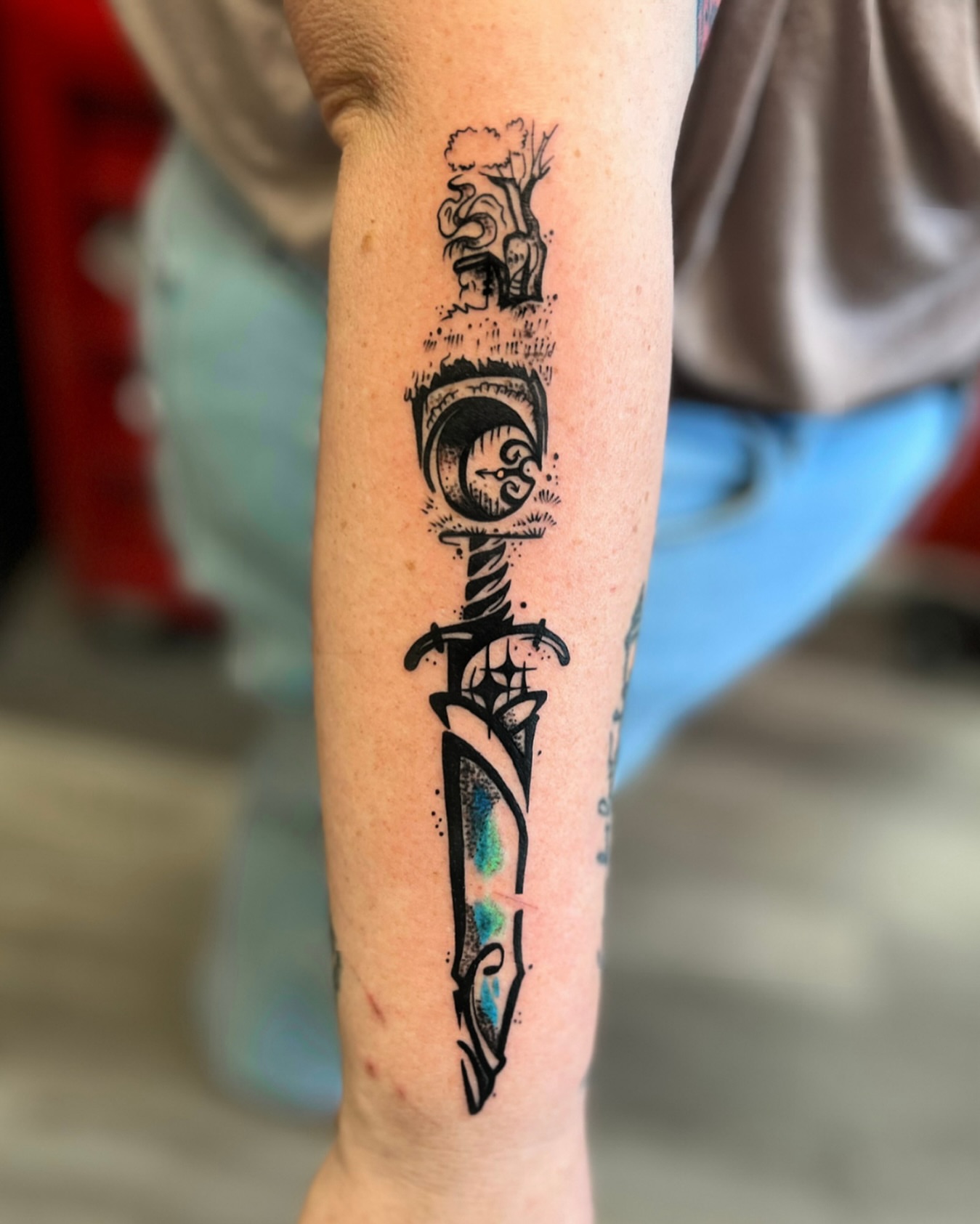 Knife with tree black and grey tattoo on the forearm by Hugh Anthony Washington, Hattiesburg, Mississippi