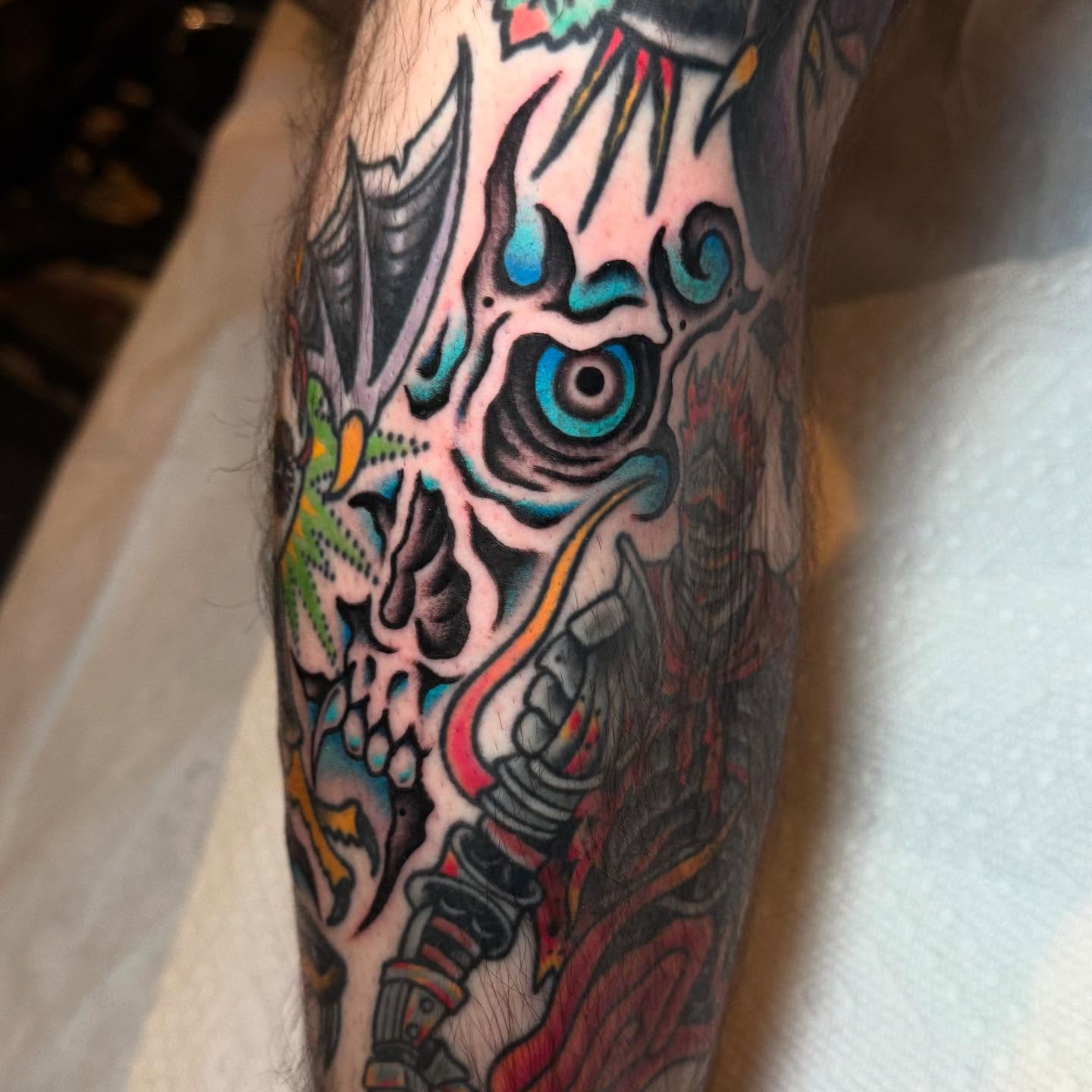 Skull with blue eyes Chicano tattoo on the forearm by Julia Louise