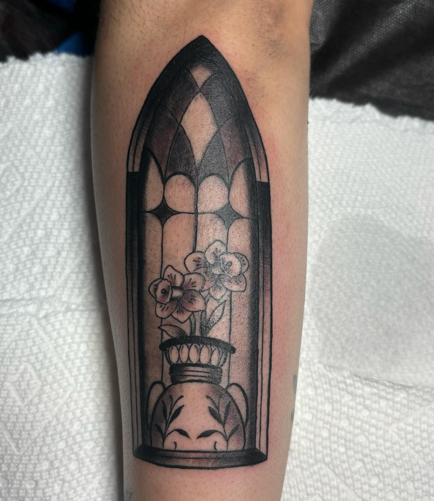 Stained glass window black and grey tattoo on the forearm by Molly Dixon