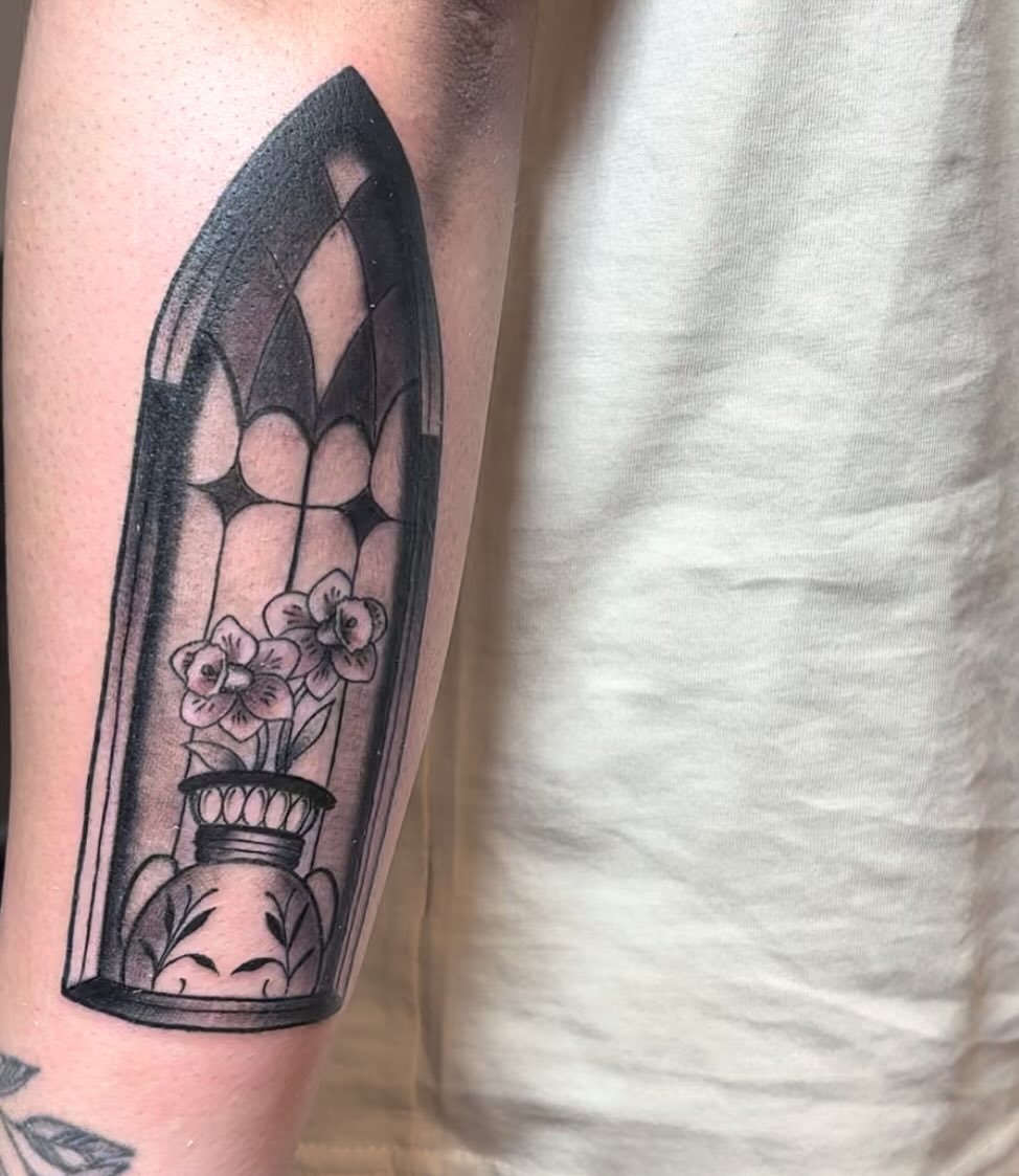 Flower arrangement black and grey tattoo on the forearm by Molly Dixon