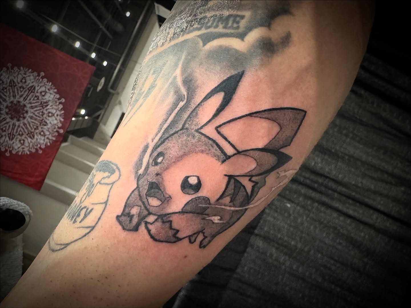 Pikachu black and grey tattoo on the forearm by Christa Martinez