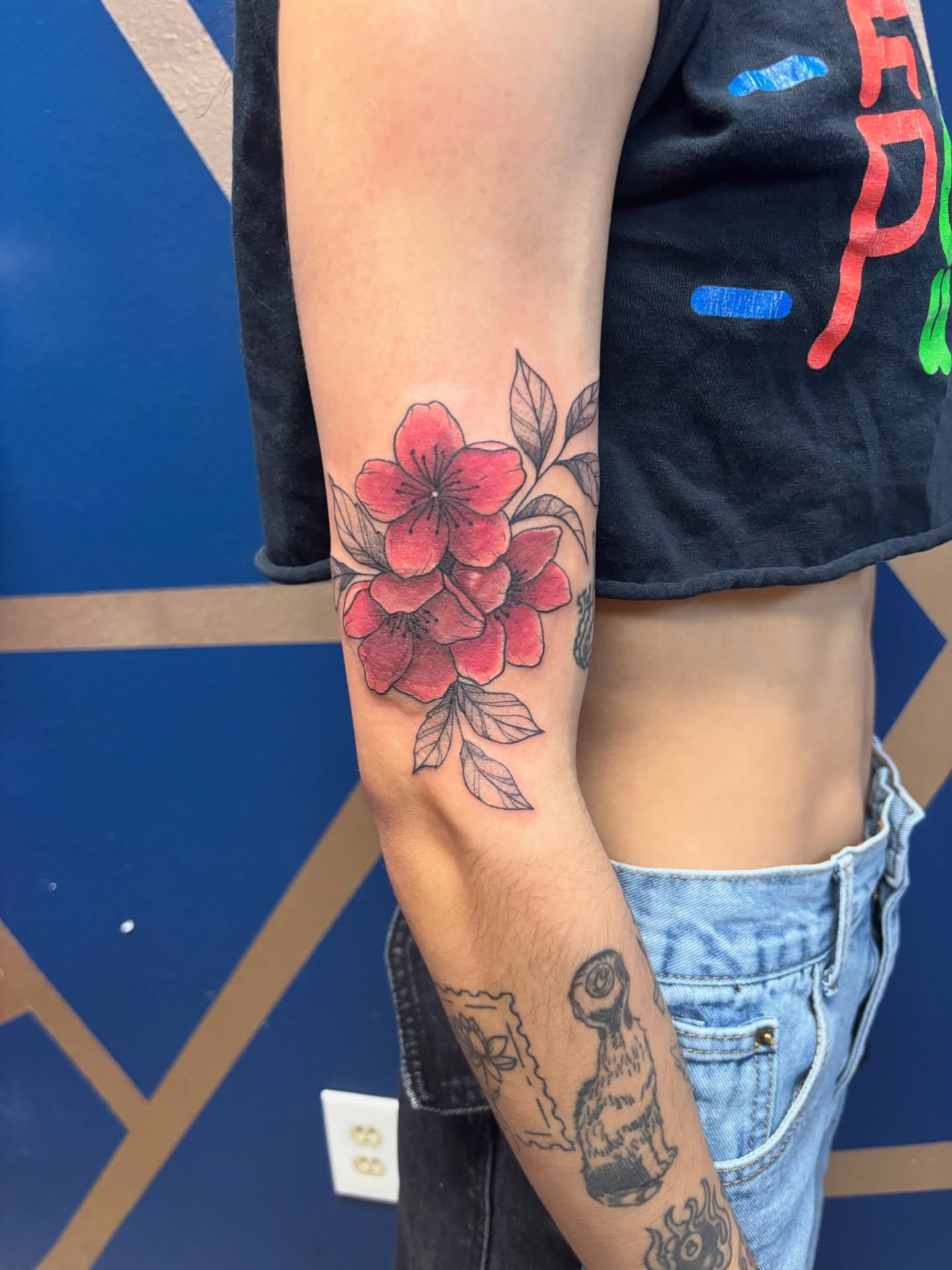 Red flowers American traditional tattoo on the forearm by ✨Cyerra Lynne✨