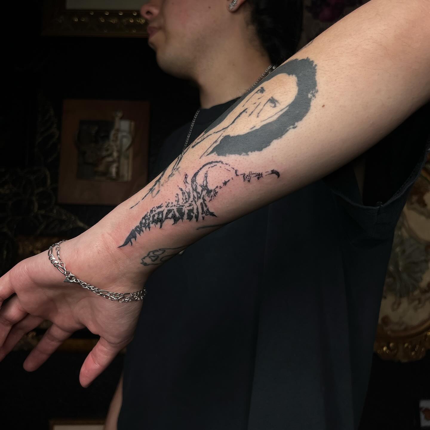 Nirvana logo black and grey tattoo on the forearm by Ladyjutsu