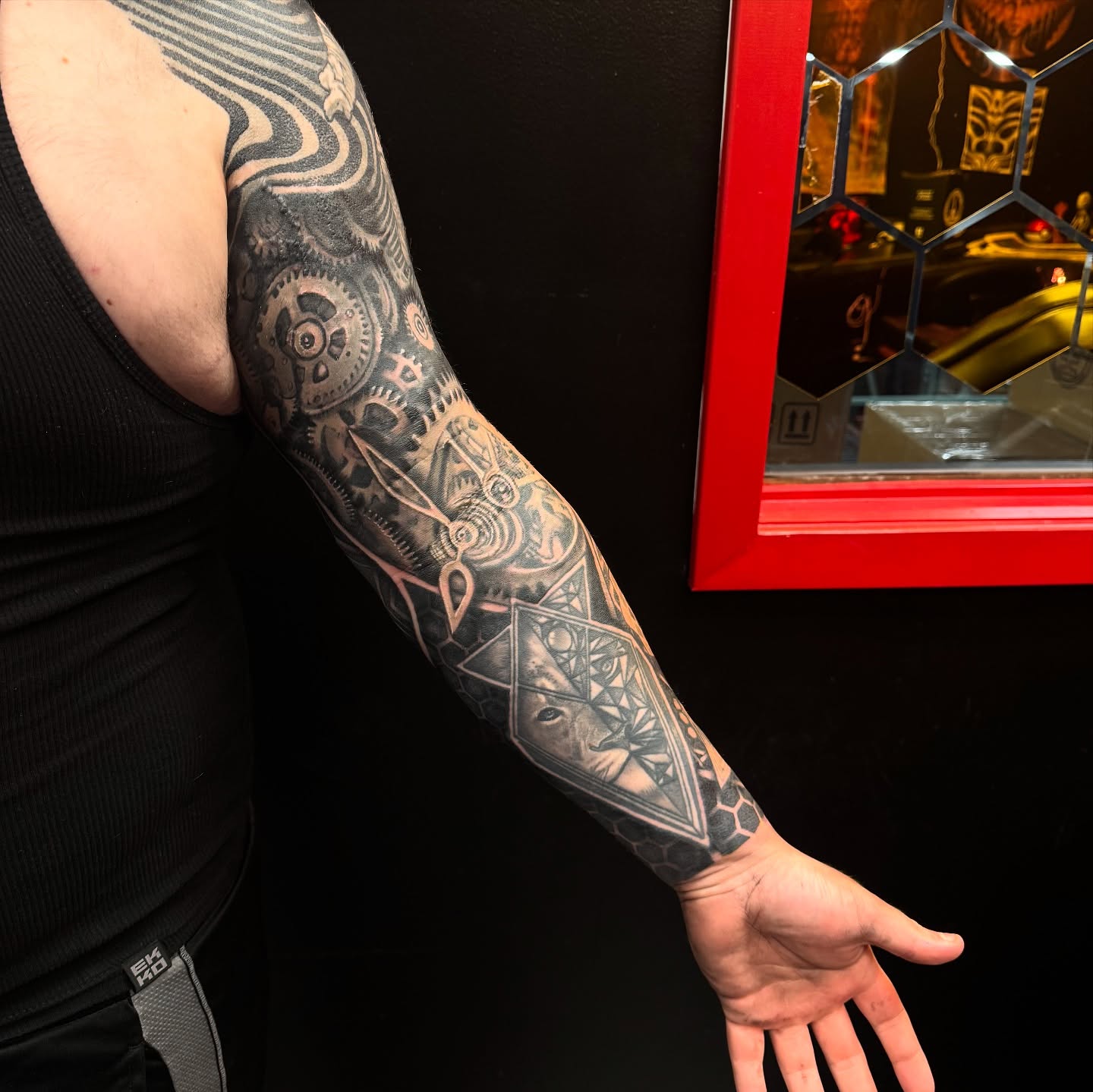 Mechanical gears and geometric shapes geometric tattoo on the forearm by Jordan Rookus