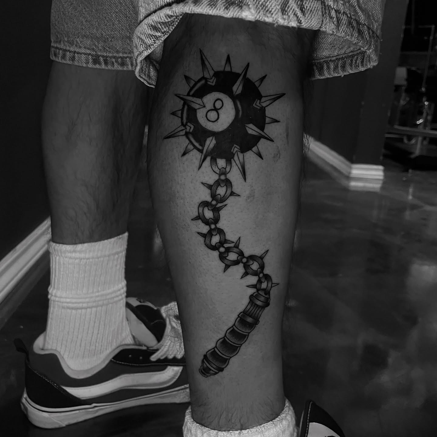 Billiard ball with spikes black and grey tattoo on the thigh by Chubbs