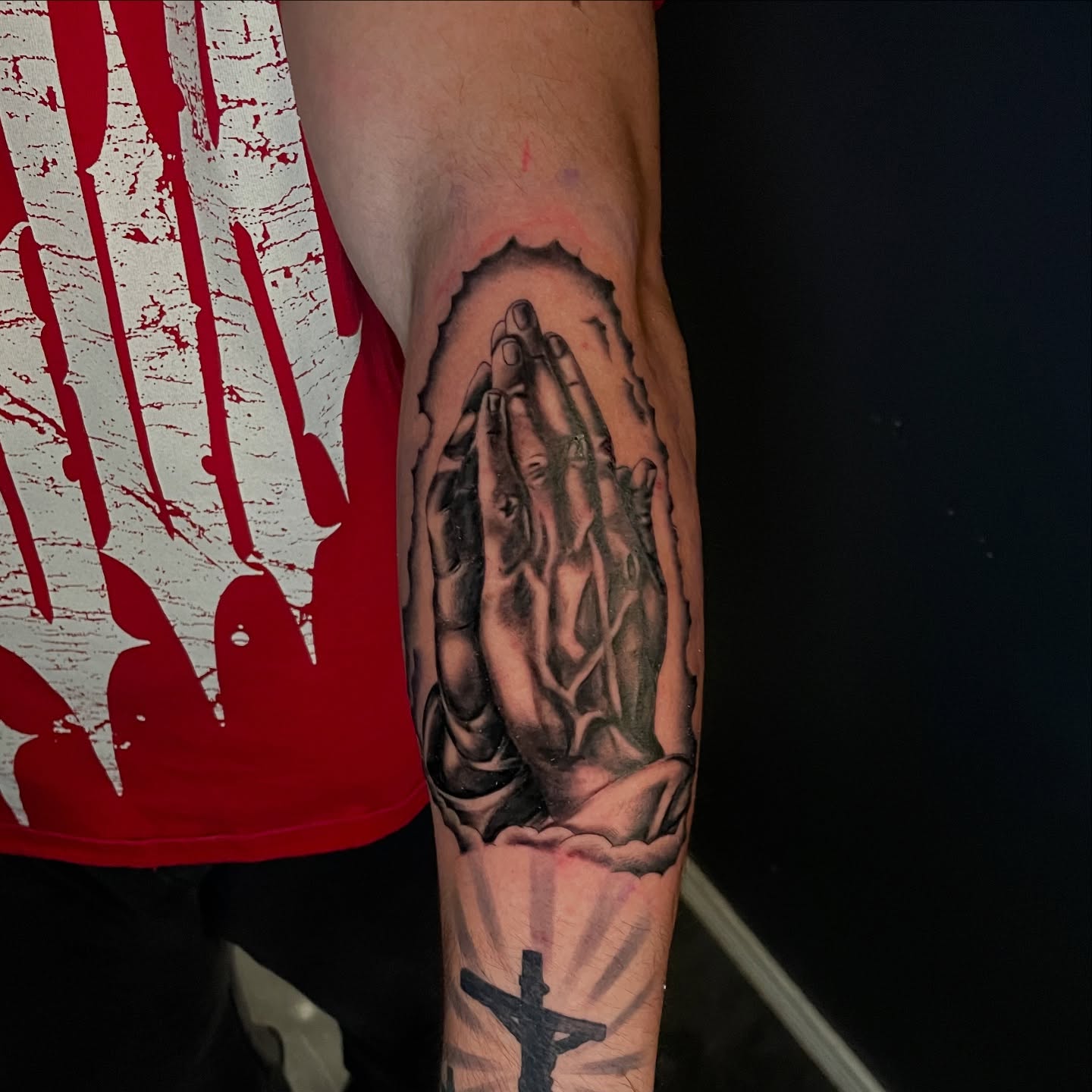 Praying hands realism tattoo on the forearm by Chubbs