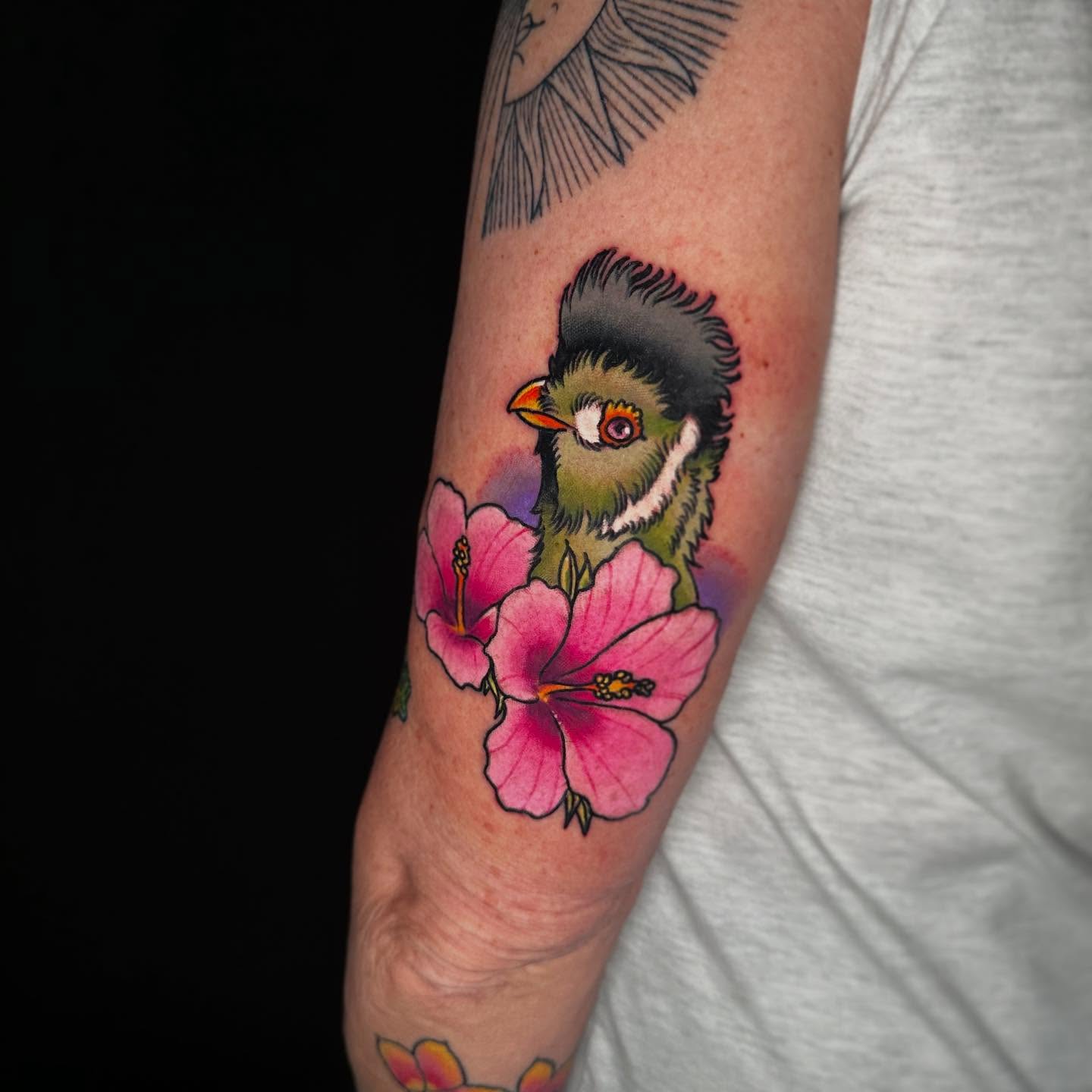 Bird and flowers realism tattoo on the forearm by John Milosh Chamberlin
