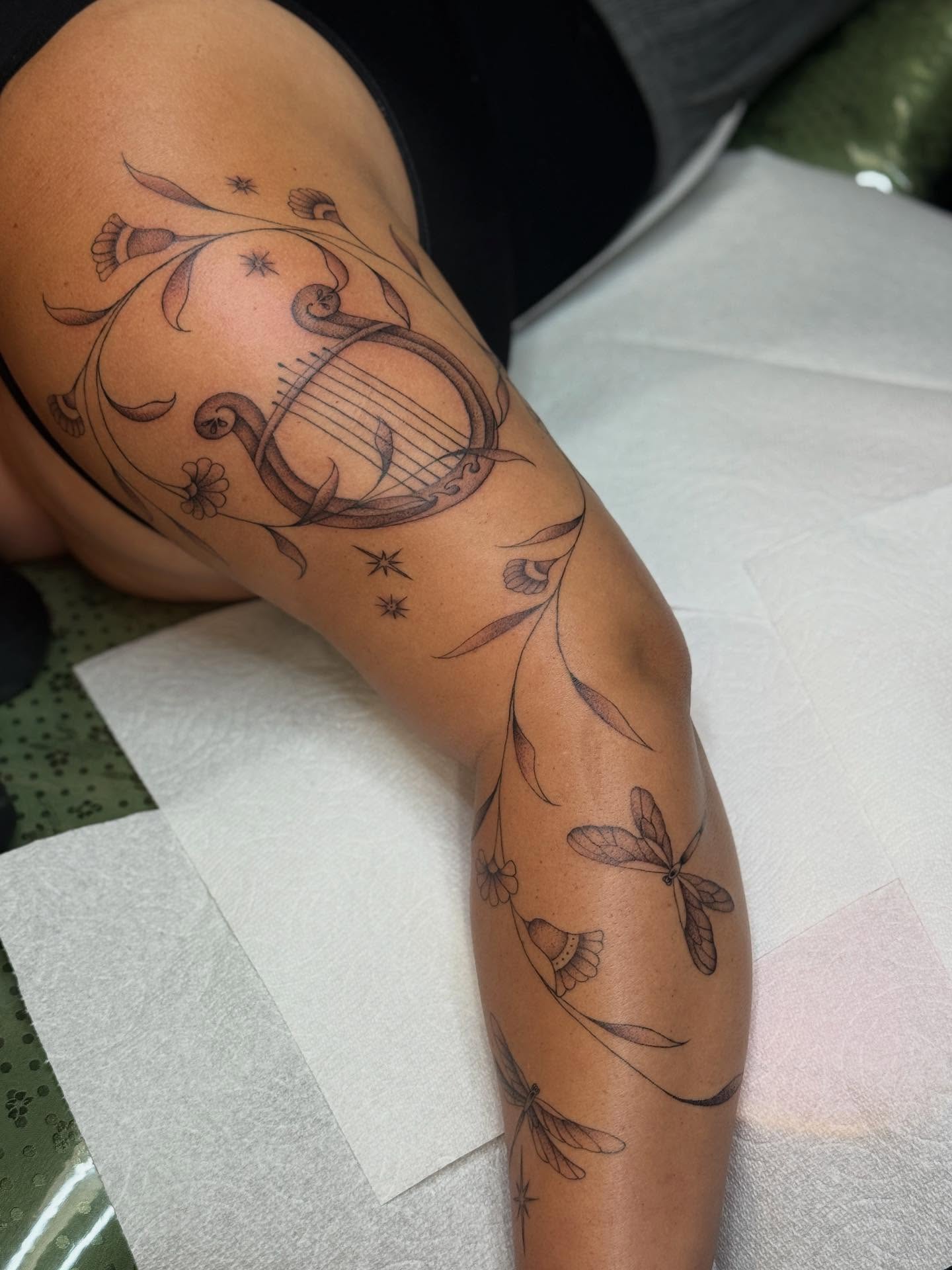 Lyre and floral vines ornamental tattoo on the forearm by chloe jeanel estrada