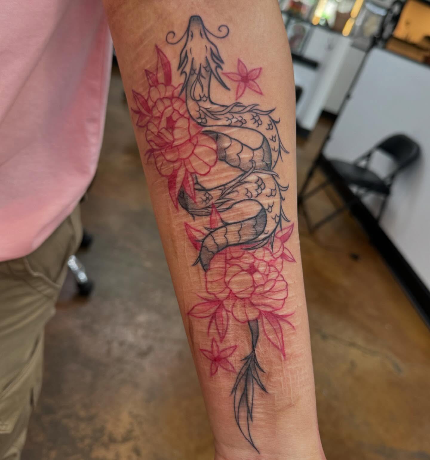 Snake and flowers new school tattoo on the forearm by Makayla Dupre